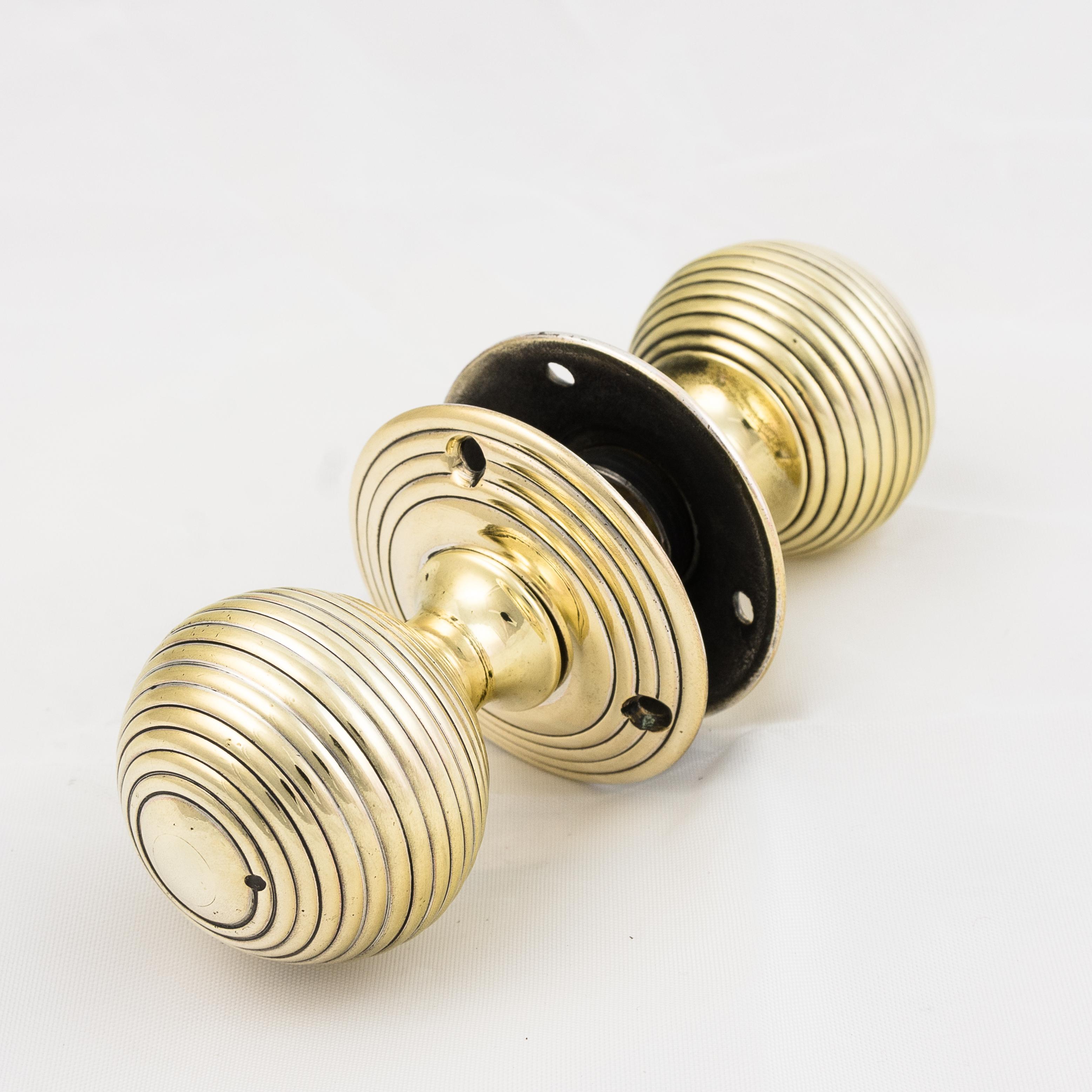 Antique brass beehive door knobs, 19th century, of reeded and of squat form.
Polished, in working order and ready for use.
