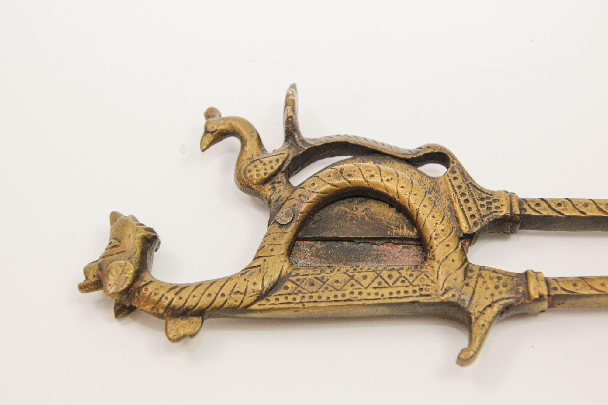 Antique betel nut cutters crafted in bronze originating from India, specifically designed for cutting betel palm, seeds, areca nuts, and dry fruits. This meticulously handcrafted collectible showcases intricate artistry, fashioned from solid brass,