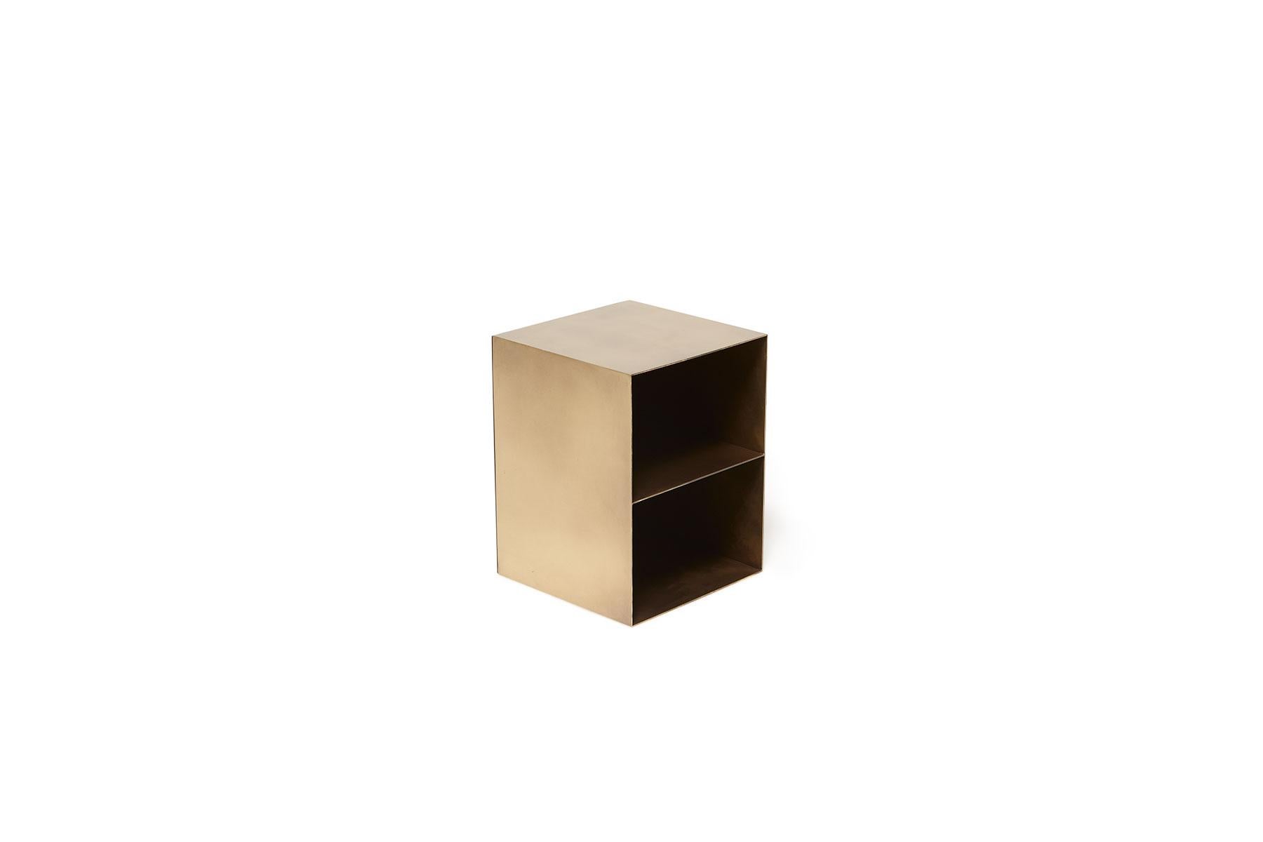 A modular stool and storage system created to accessorize a living space. Can be used facedown to act as stools or a small coffee table or turned upright to act as a small shelving or storage unit. Shown here in antique brass. Also available in