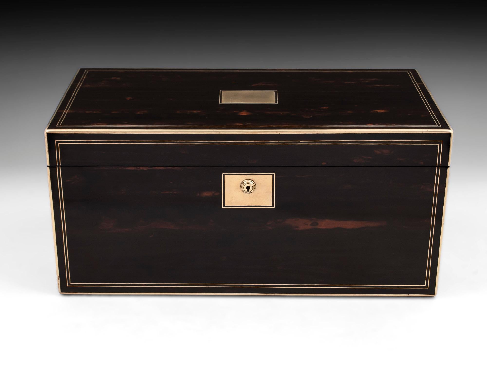 Antique writing box veneered in Coromandel with brass edging and double stringing, with a large vacant brass initial plate on the top and matching lock escutcheon, contains two secret compartments one with three drawers and another top secret