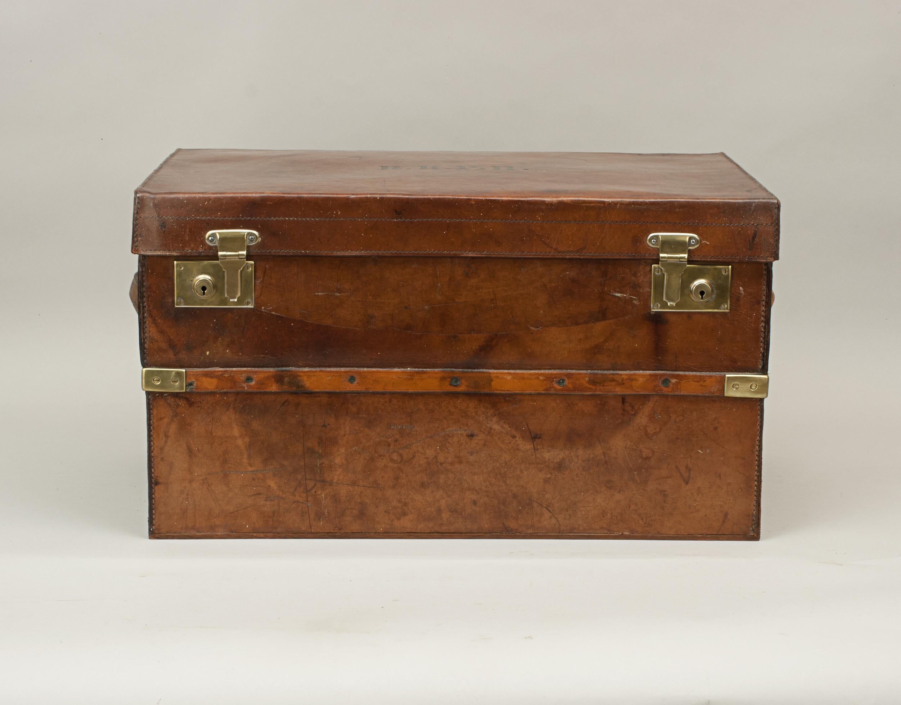 Brass Bound travelling trunk.
A sturdy leather bound travel trunk with brass locks and strapping with leather carry handle at either end. The top embossed 'R.R.P.H'. made by Webb & Bryant, Southsea. The interior sound and clean. The trunk has been