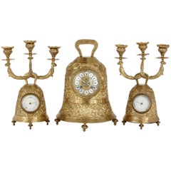 Antique brass clock set with religious decoration