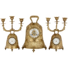 Used brass clock set with religious decoration 