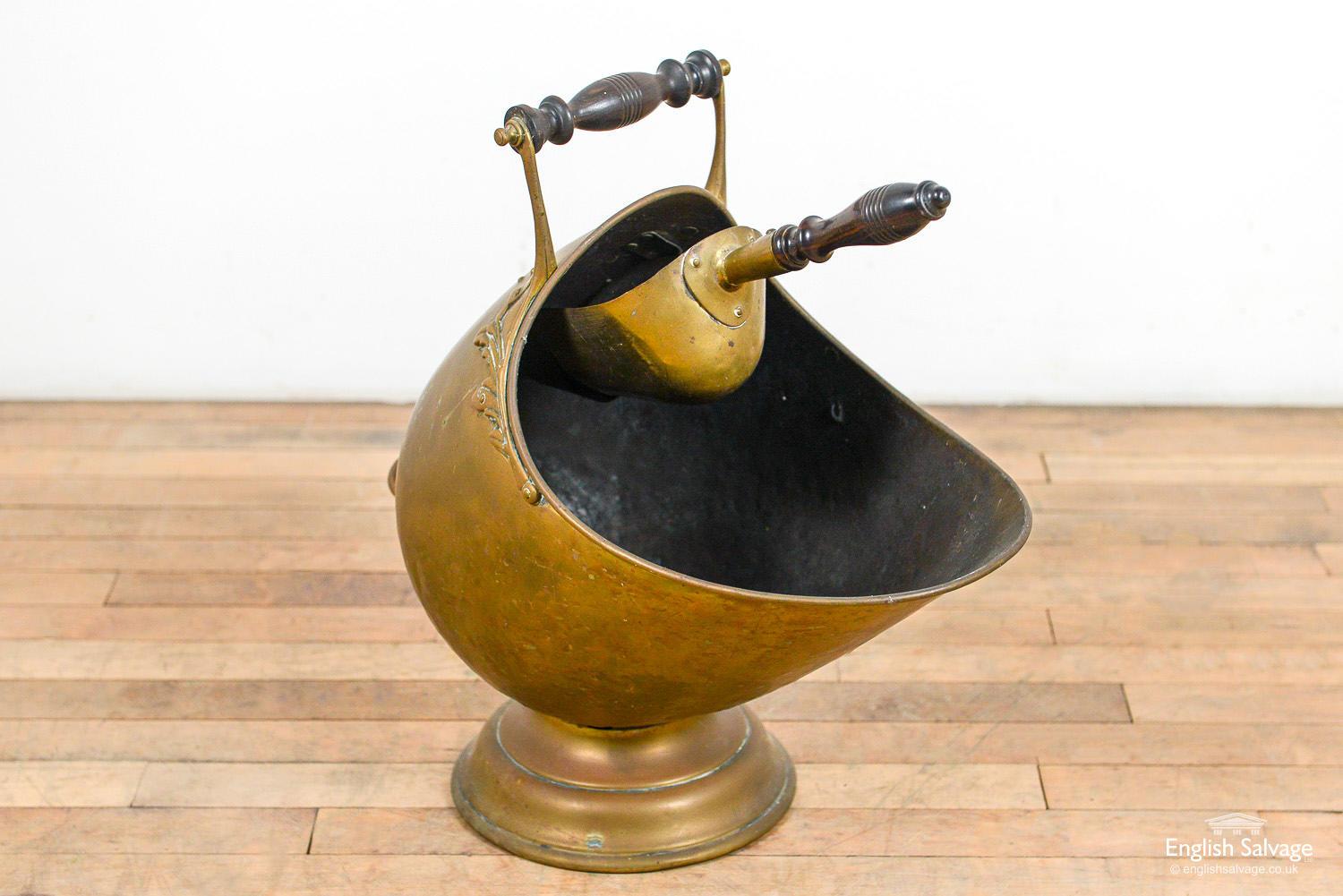 Substantial fireside brass coal bucket with scoop. Turned hardwood handles and decorative floral detail around rim. An unusual find with a lovely patina, and only minor age-related scuffs and dinks.