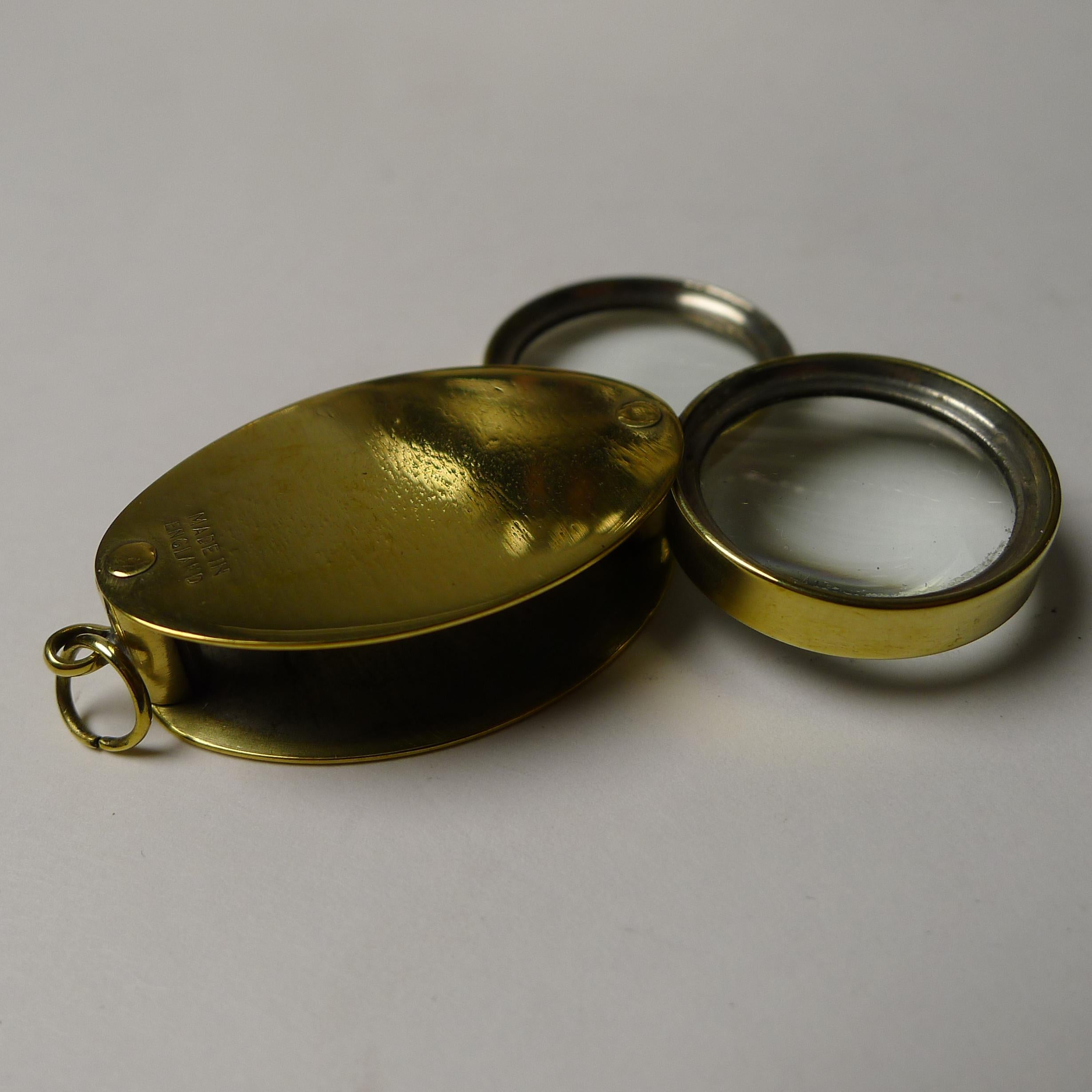 A pocket sized double lens magnifying glass made from solid English brass, stamped both sides 