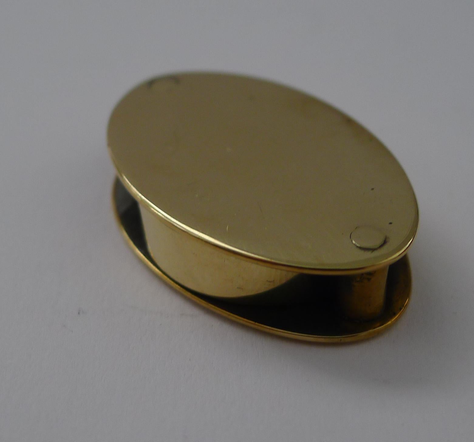 A small folding magnifying glass or loop, made from solid English brass dating to c.1920.

One lens sits nicely between the back and front panels folding away while unused, fitting into the pocket.

Excellent condition measuring 1 1/2