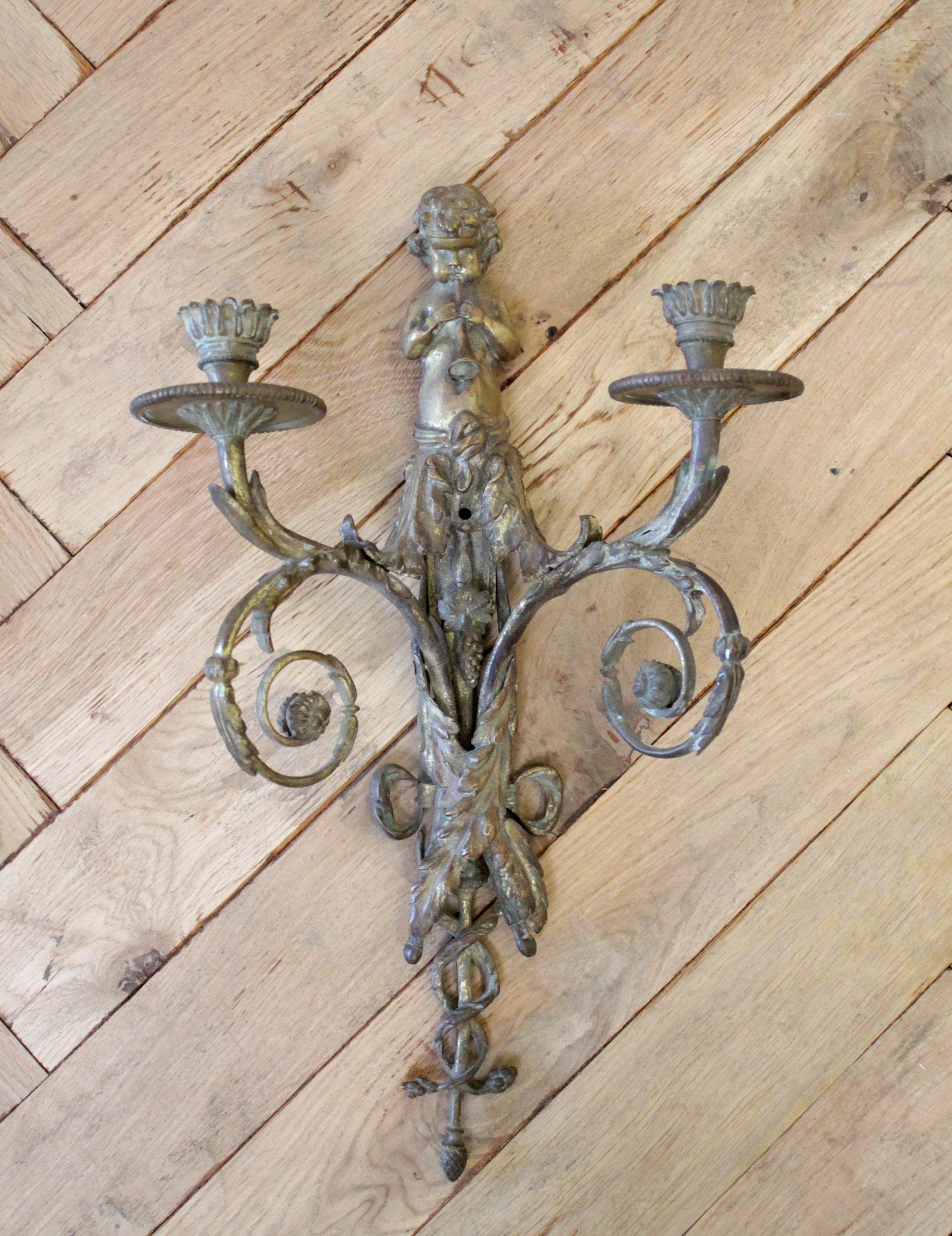 Antique brass French sconce with cherub playing the flute. Great patina, ready to hang on the wall. We just have 1 only, not a pair.
This sconce uses candles, and measures: 10