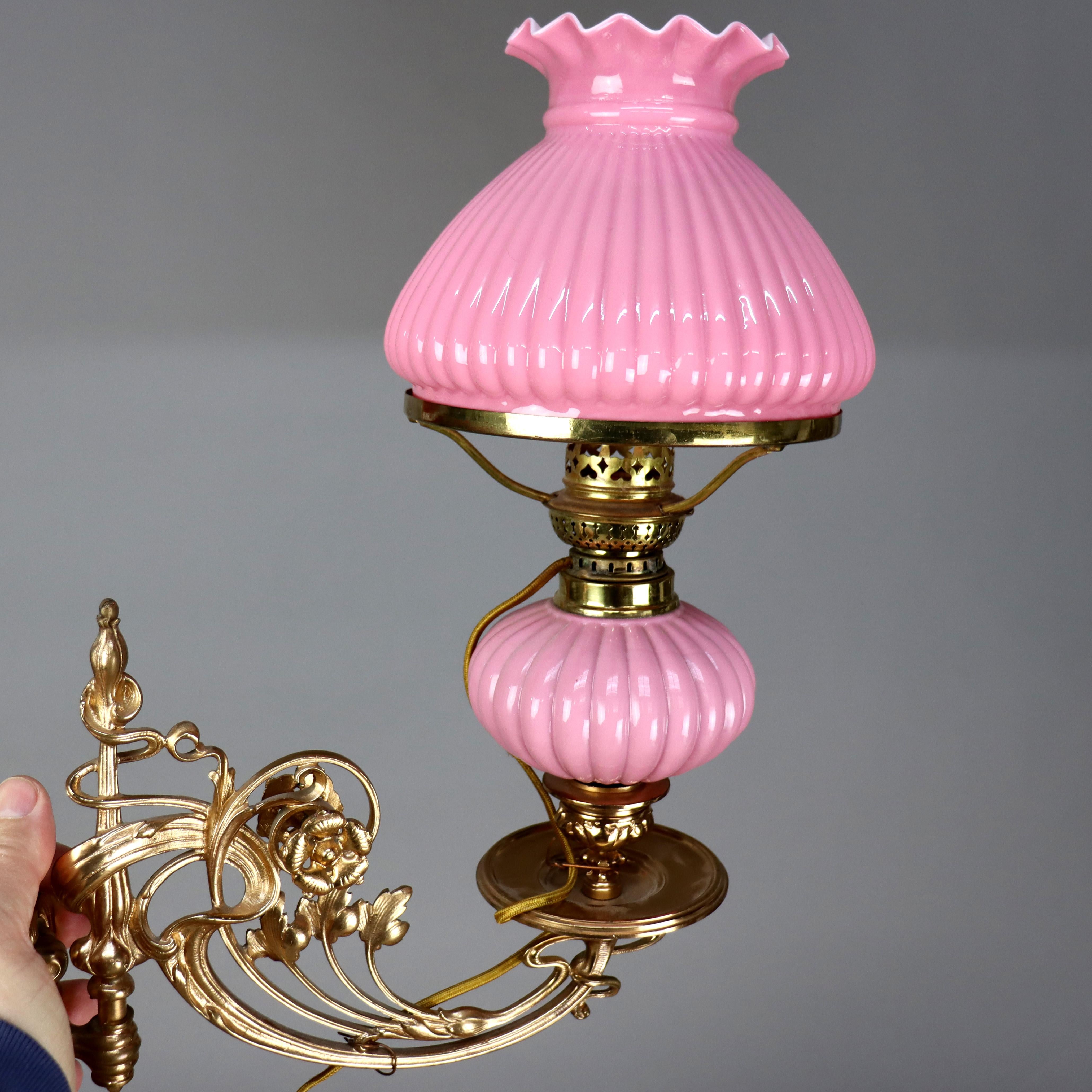 Pair of Antique Brass & Gilt Bronze Wall Sconces with Ribbed Pink Cased Glass Shades, Electrified, c1890.

Measures - 14