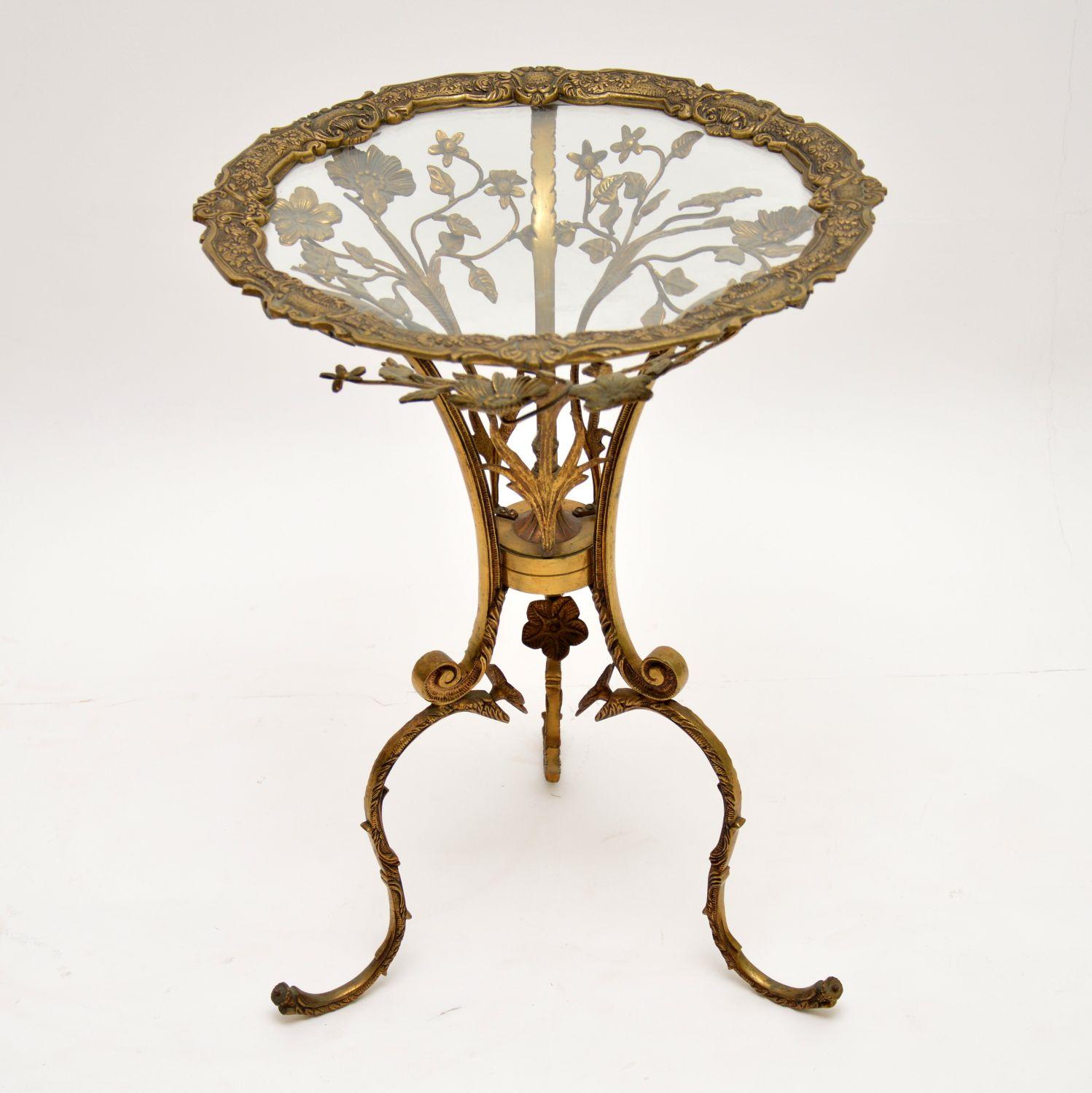 Antique brass side table with some very intricate castings and a lot of floral decorations. It has a glass top so all the flowers can be seen through the top and it would make an excellent lamp table. I would date this to around the 1930s-1950s