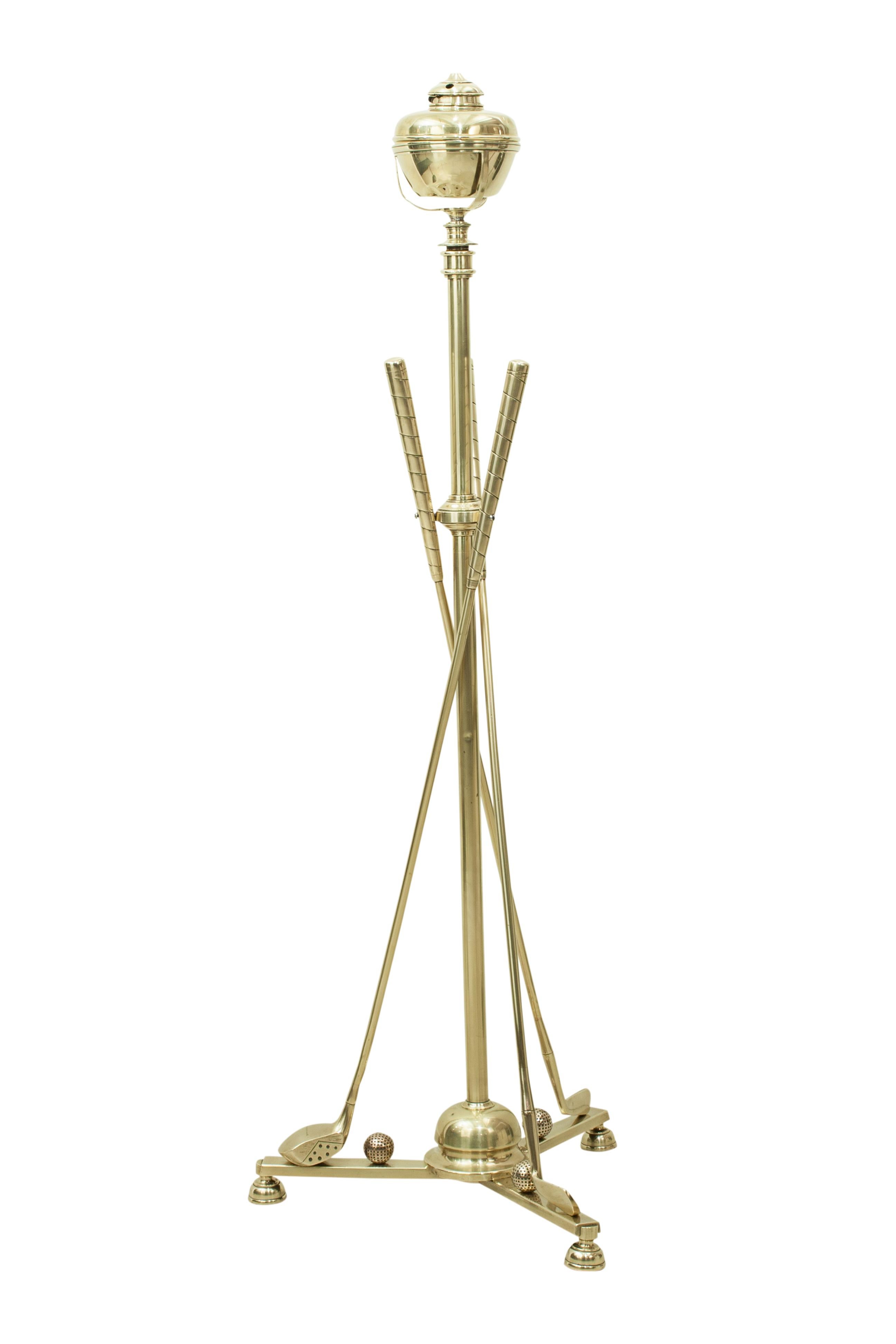 Antique brass golf lamp with three golf clubs.
An excellent quality telescopic brass floor lamp, the central tubular standard issuing from a triform platform base mounted with three golf clubs and three golf balls. The three brass clubs on the base