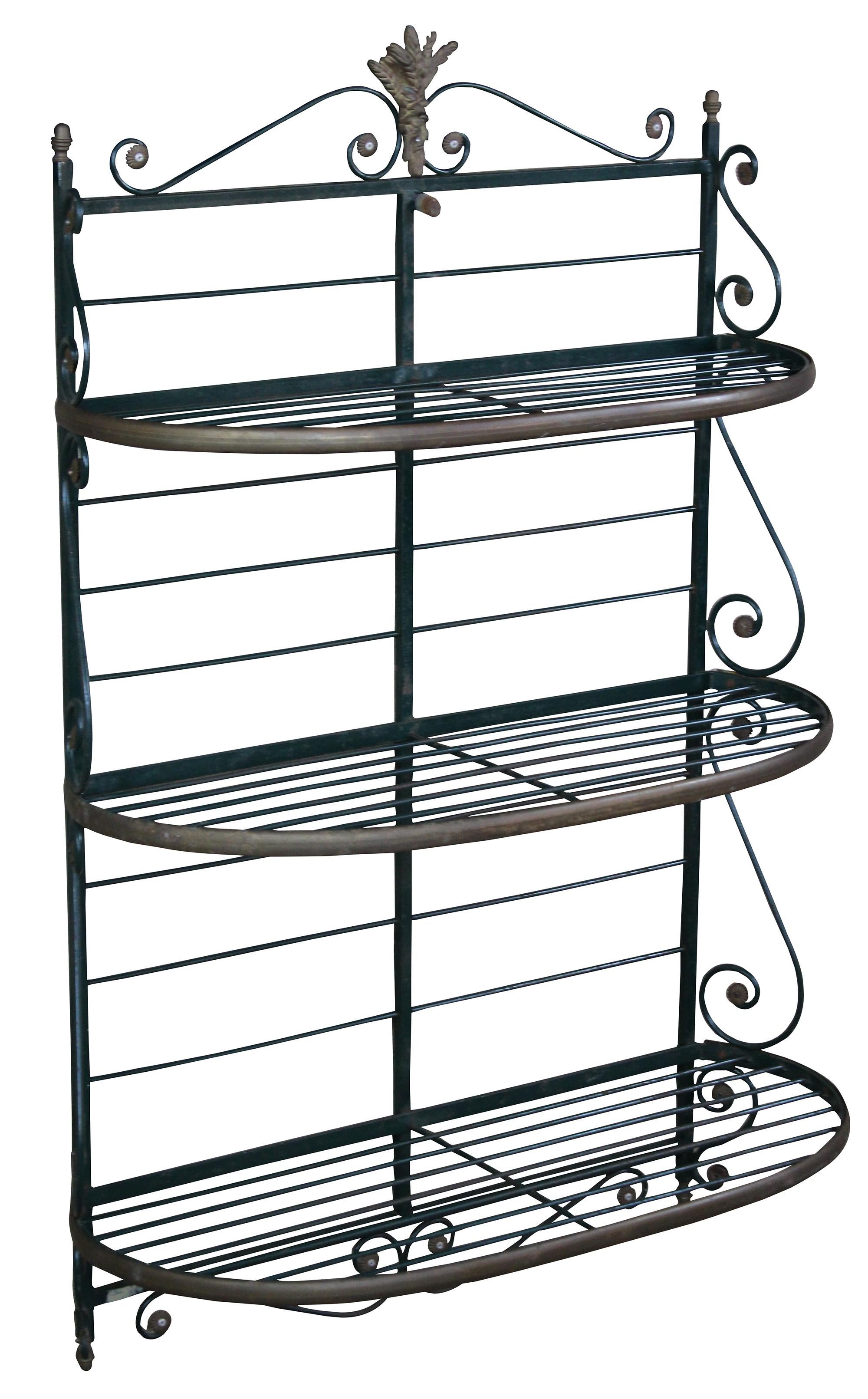 Early 20th century French bakers rack. Made of scrolled iron and brass with a green vertigris patina. Measure: 52