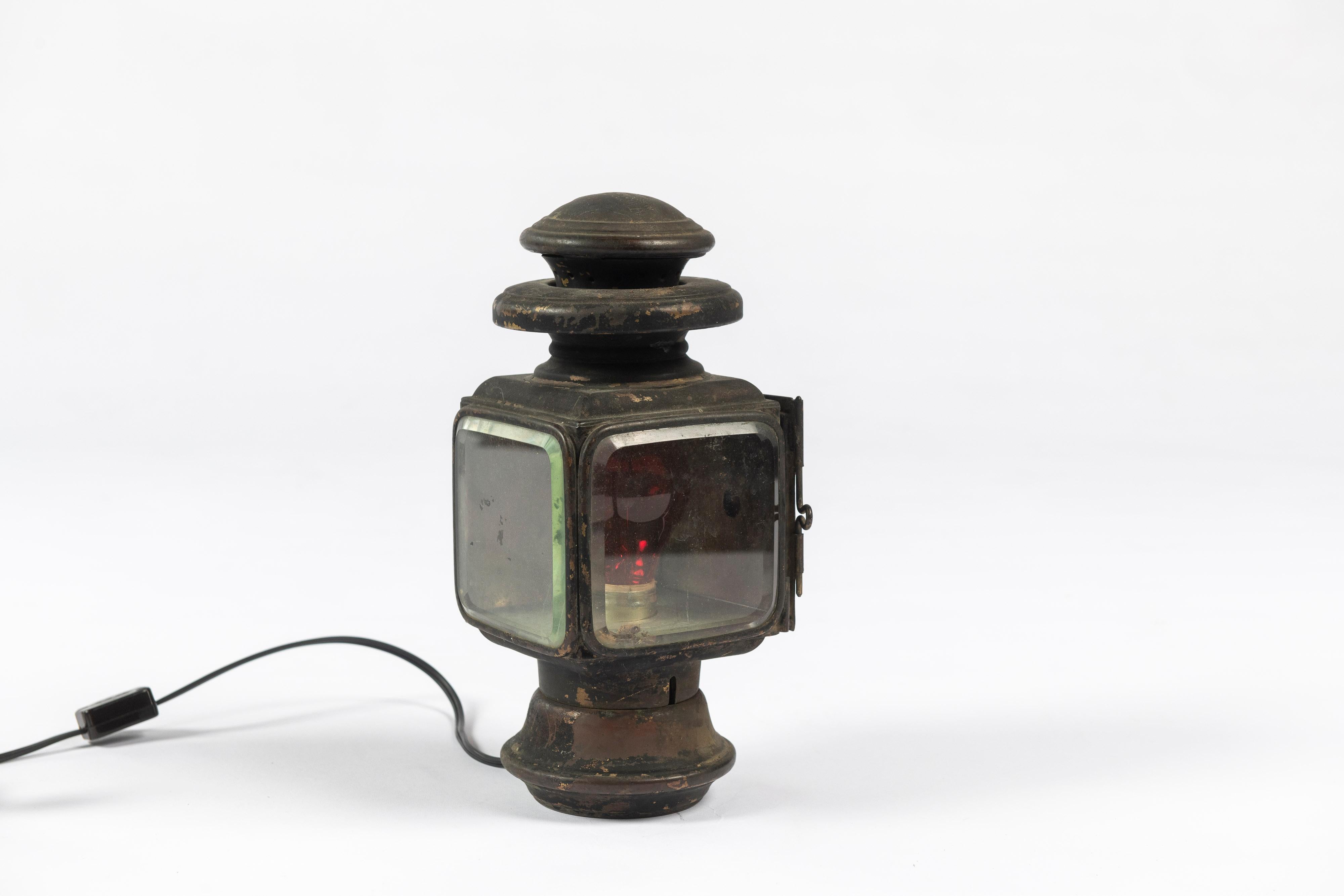 This lamp was designed and made at the turn of the 19th Century to be used as a headlight for a car or buggy, and was originally lit with a wick. It's been wired to bring a bit of that steampunk feeling to a table, credenza or that spot where you