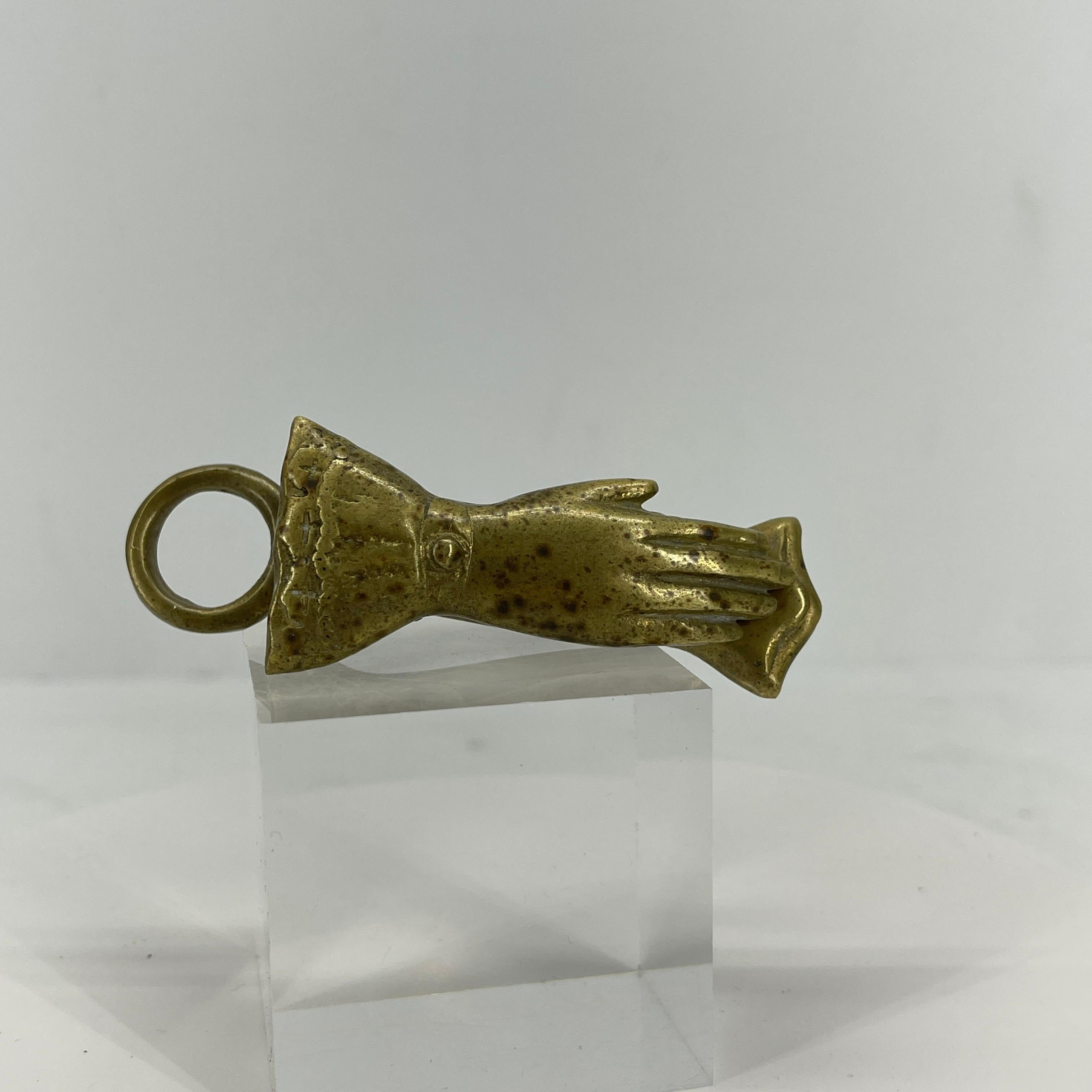 Antique brass letter or envelope holder. In the shape of a delicate hand, this petite clip with an end ring will not only look handsome on a desk, but is quite capable of holding papers, envelopes or a stack of photographs. Reminiscent of a vintage