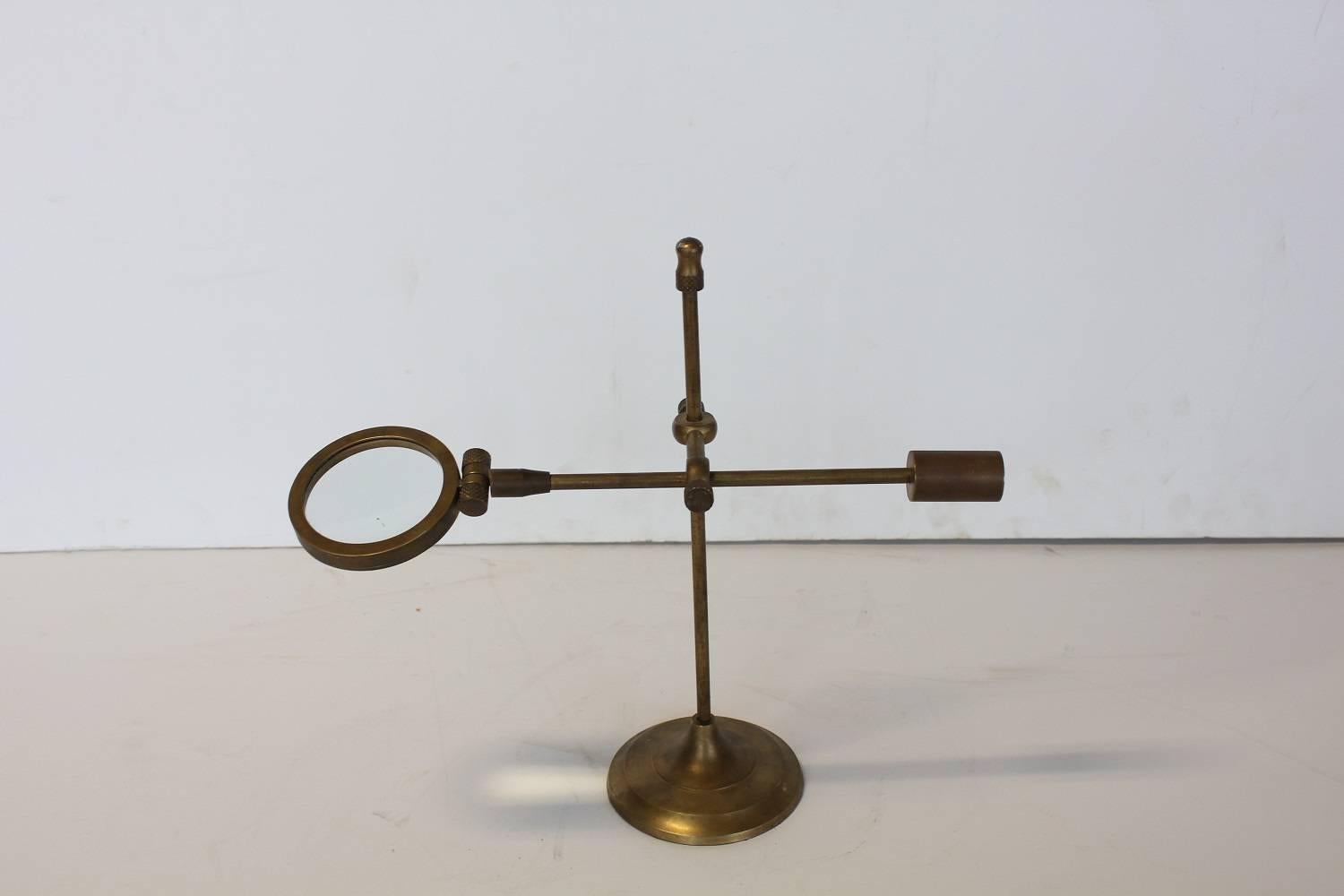 Antique brass magnifying glass on stand.