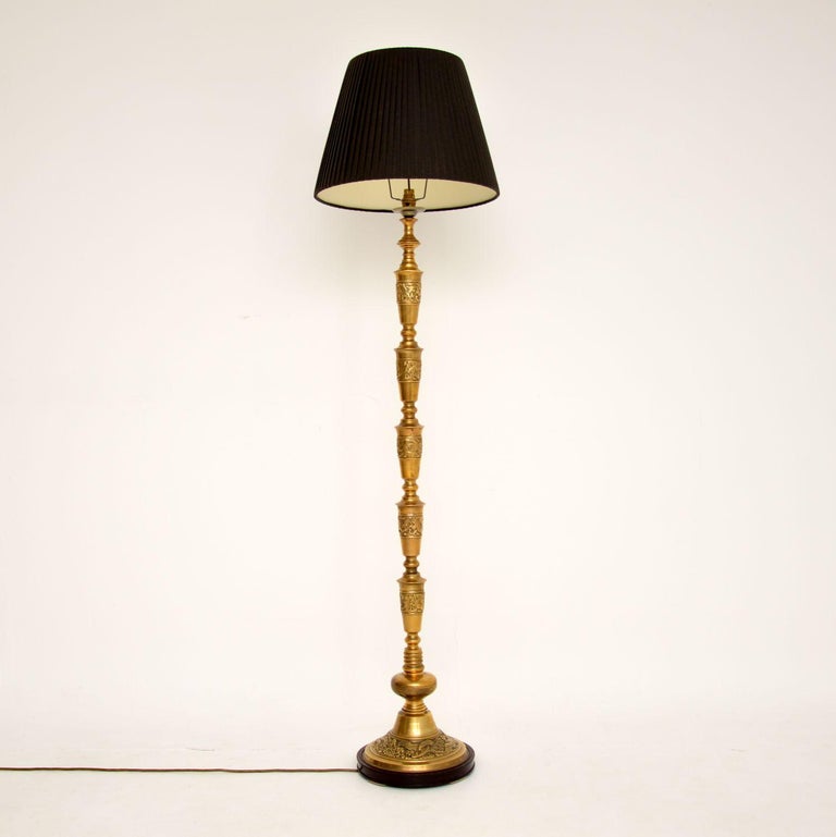 A wonderful antique solid brass floor lamp sitting on a solid wood base. This was most likely made in England & is neoclassical style, dating from around the 1930’s.

It is beautifully made, with intricate details and a stunning design. This is a