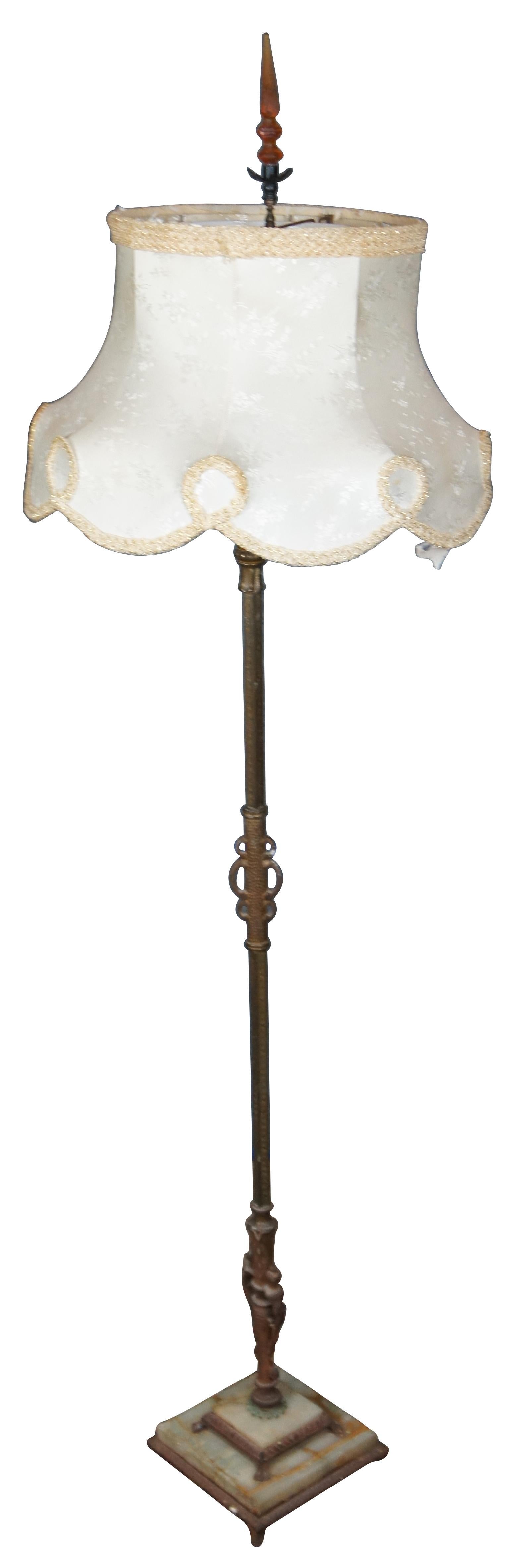Late 19th-early 20th century large floor lamp with an iron and white marble base, brass body with candelabra sockets for three candle shaped bulbs and main torchiere style top with milk glass shade, all topped with a scalloped silk shade with amber