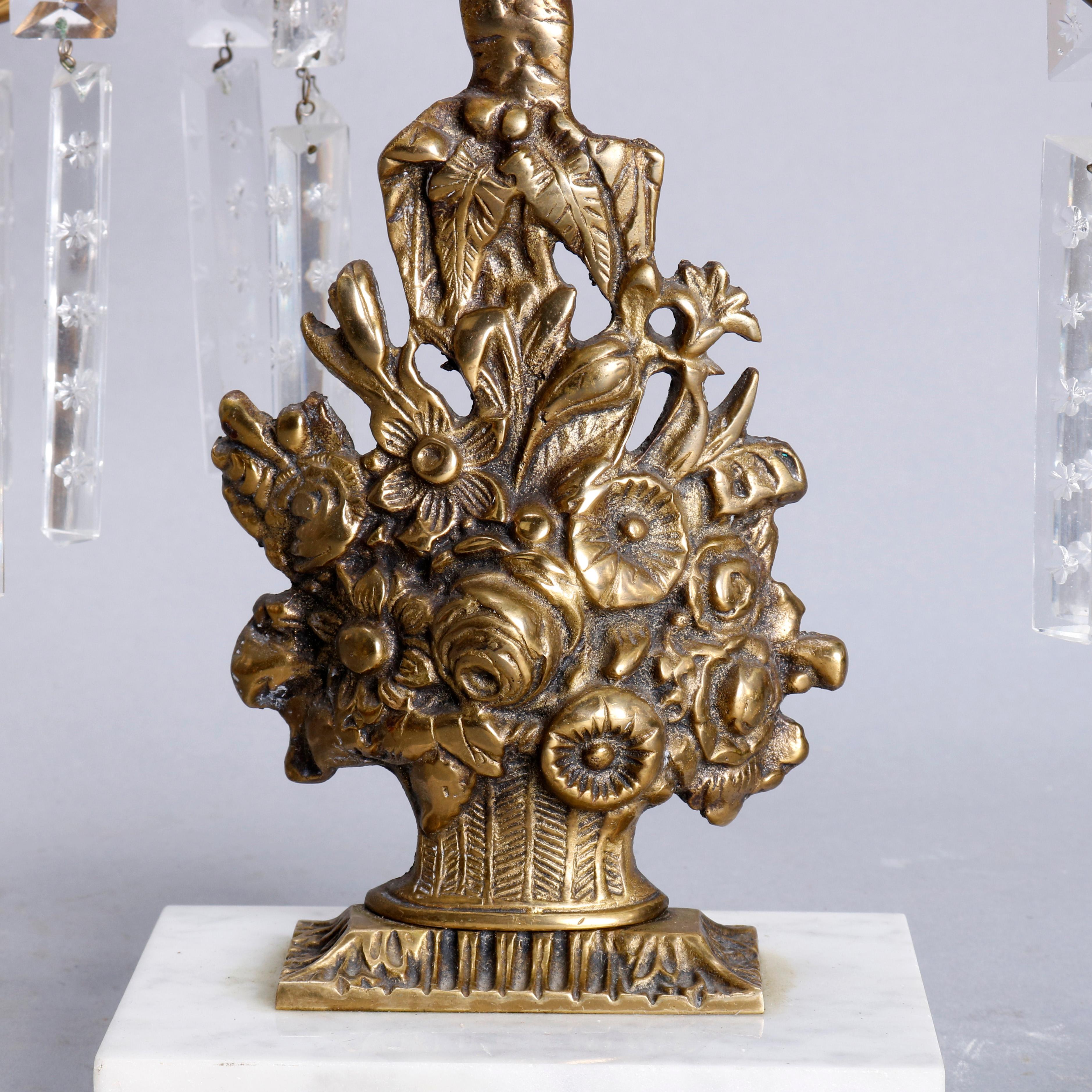 An antique girandole candelabra set offers cast brass Panier de Fleurs, basket of flowers, having three foliate form arms terminating in candle sockets with hanging crystals and seated on marble bases, circa 1880

***DELIVERY NOTICE – Due to