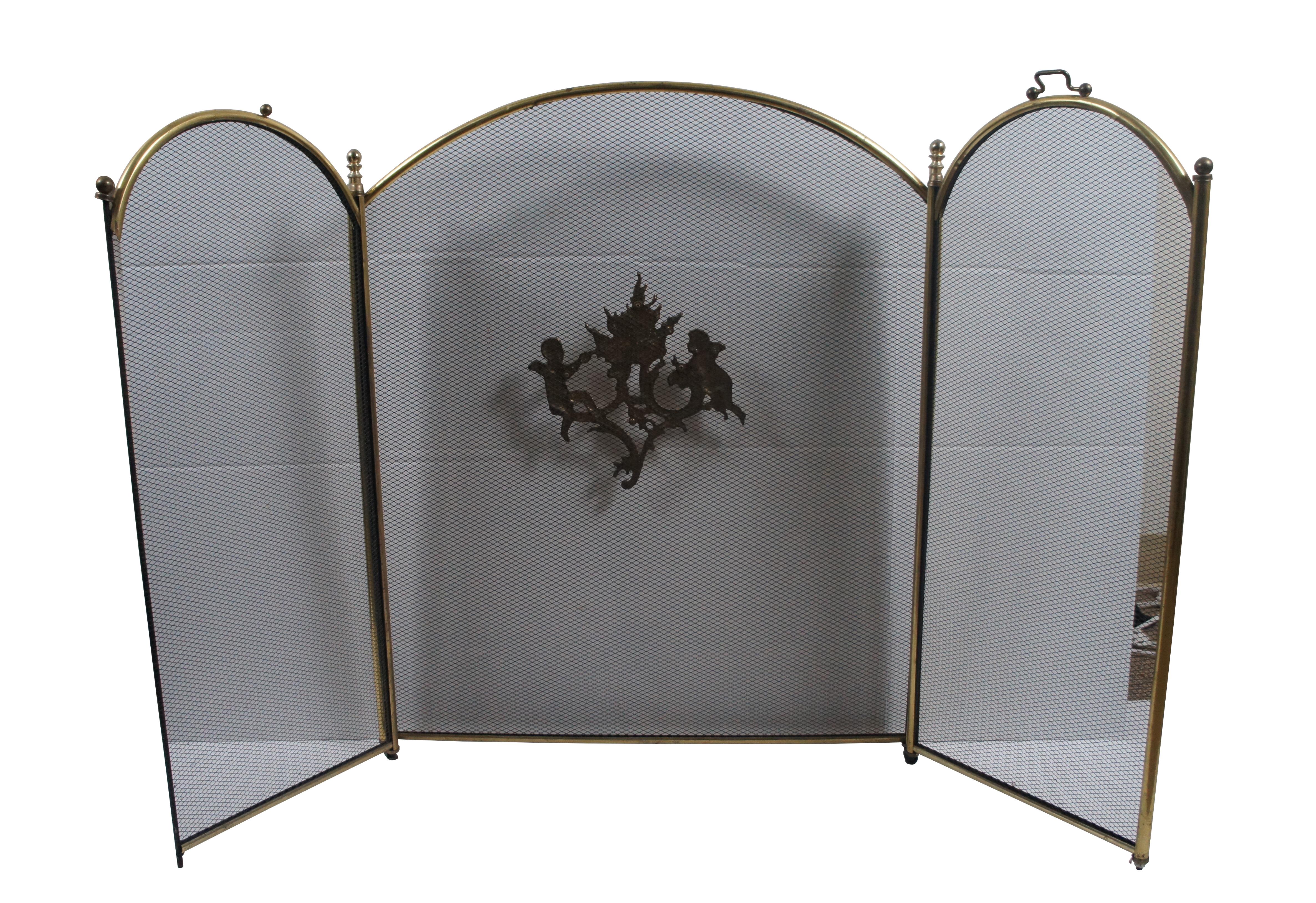 Antique brass and metal mesh fireplace / hearth screen featuring three arch topped folding panels, round finials, and squared off handles. The central panel is embellished with an applique showing a pair of cherubs stoking a fire.

Dimensions:
50