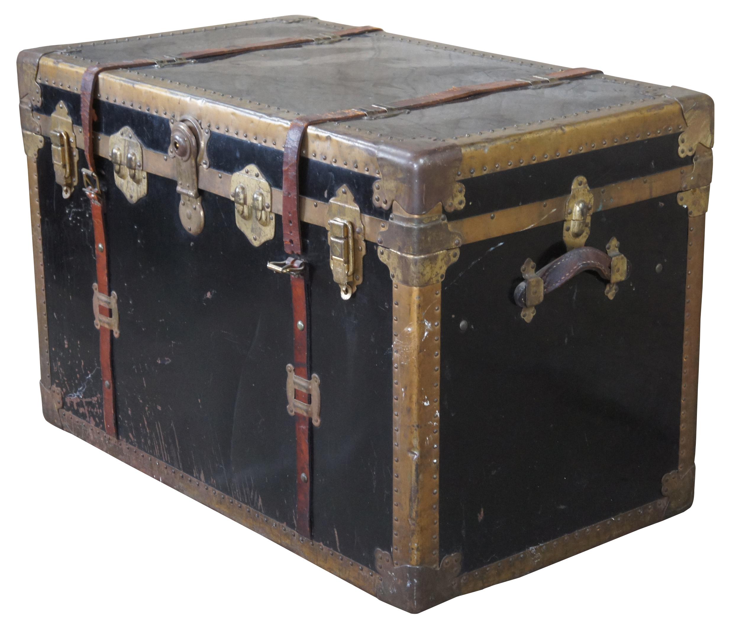 Antique Victorian steamer trunk or chest. Made of metal and brass with nailhead trim and leather straps and handles. Features interior compartment for organizing clothing / accessories.
 