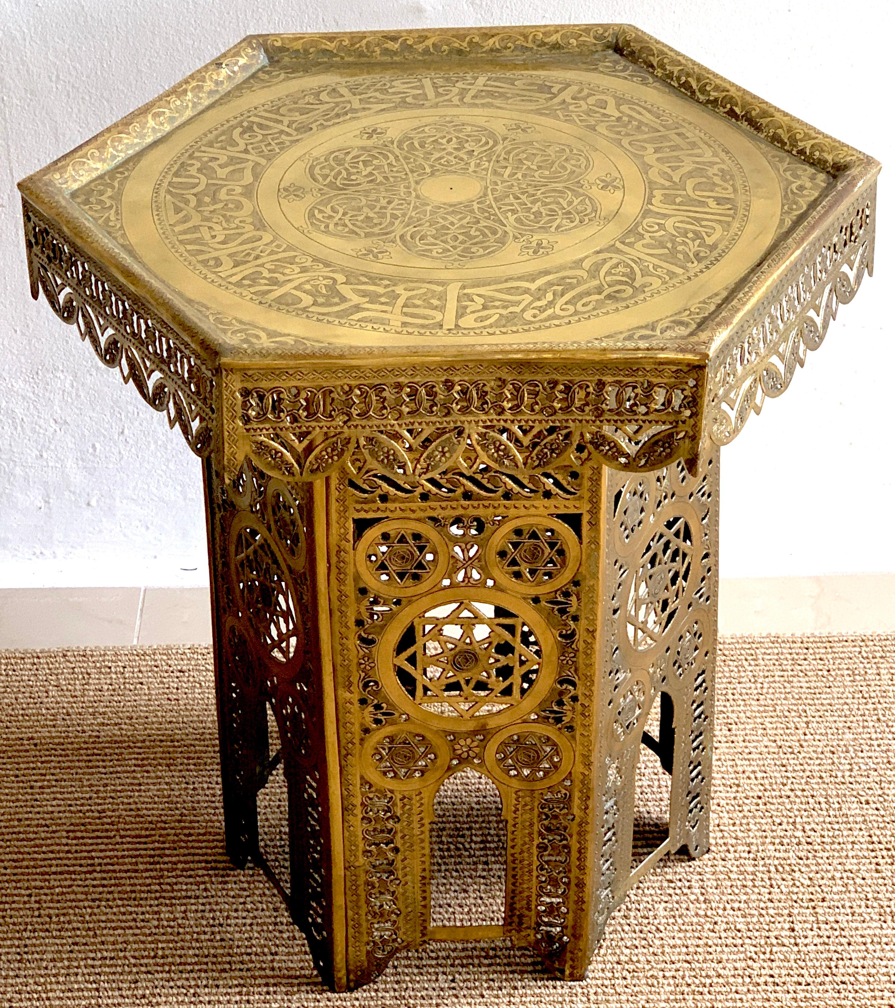 Antique brass Moorish side table, of hexagonal shape with all-over chased decoration, the inset 18.5-Inch. diameter top with custom glass top (not shown, but is included) raised on a pierced conforming pedestal base
The outside tabletop diameter is