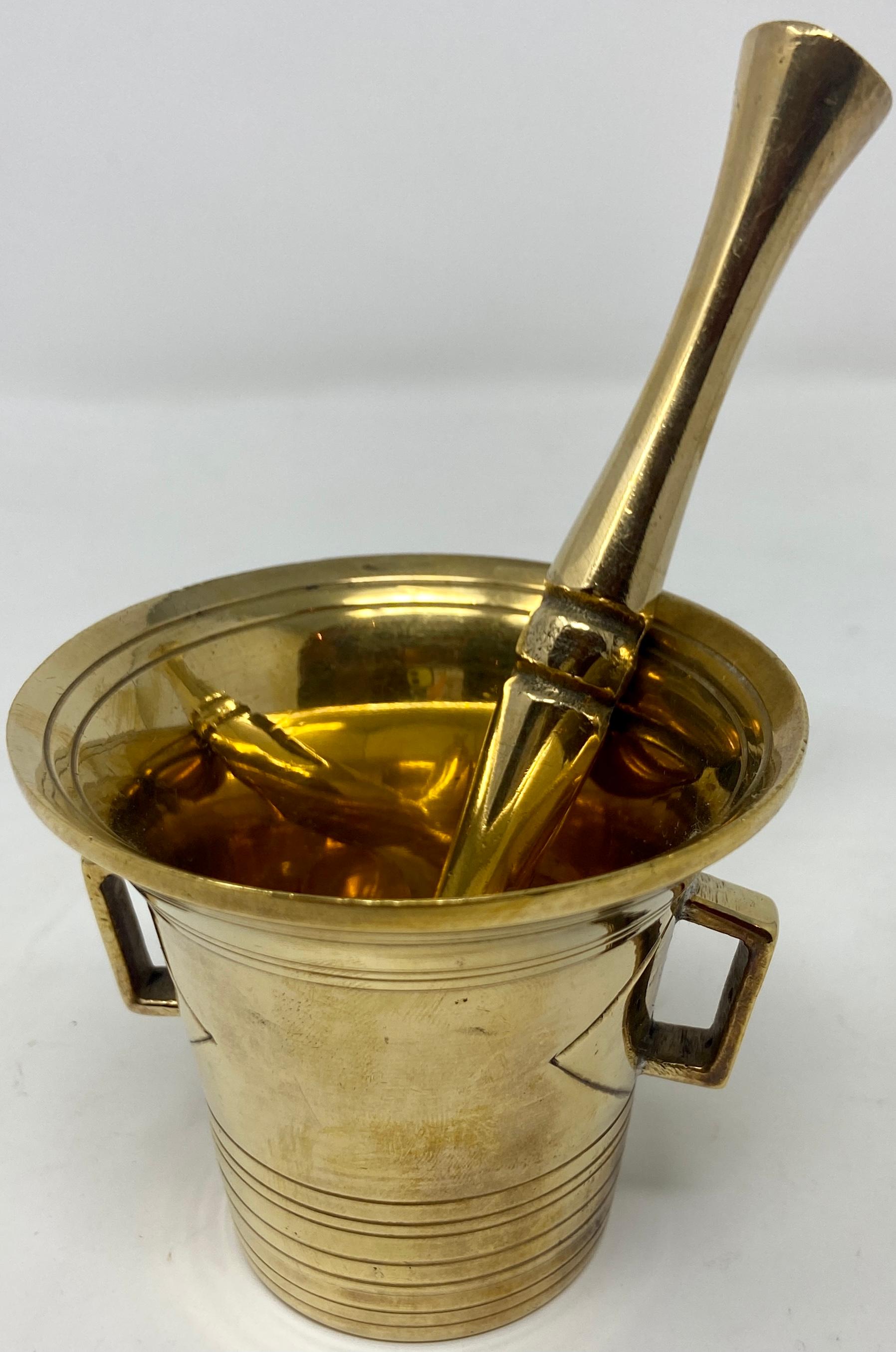 Antique brass mortar and pestle, Circa 1920.
Used in both household kitchens and apothecaries / pharmacies for centuries.