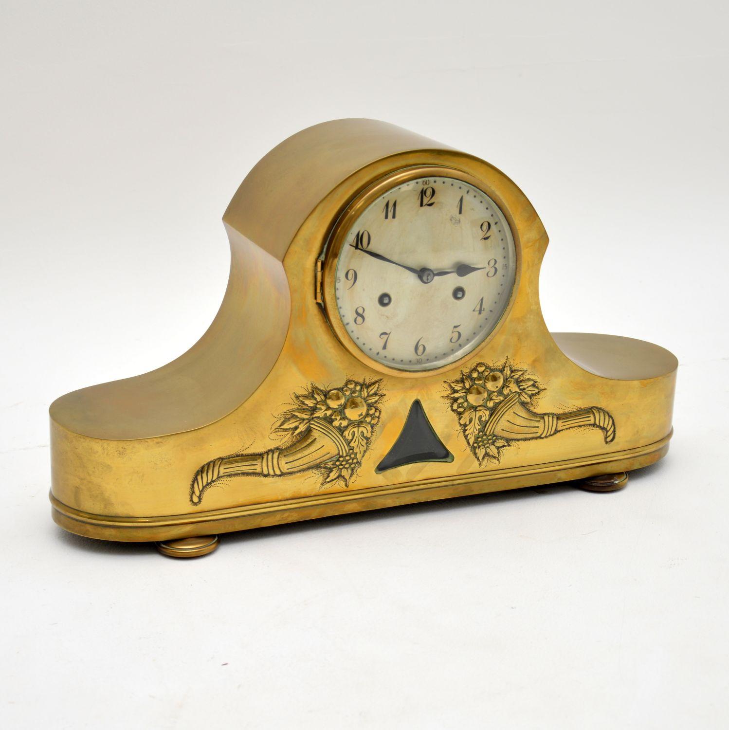 A stunning antique brass mantel clock, this was made in Germany and dates from circa 1900-1910 period. It was made by the renowned clock maker Junghans of Wurttenberg, the makers mark is seen stamped inside.

This model is known as a Napoleon hat