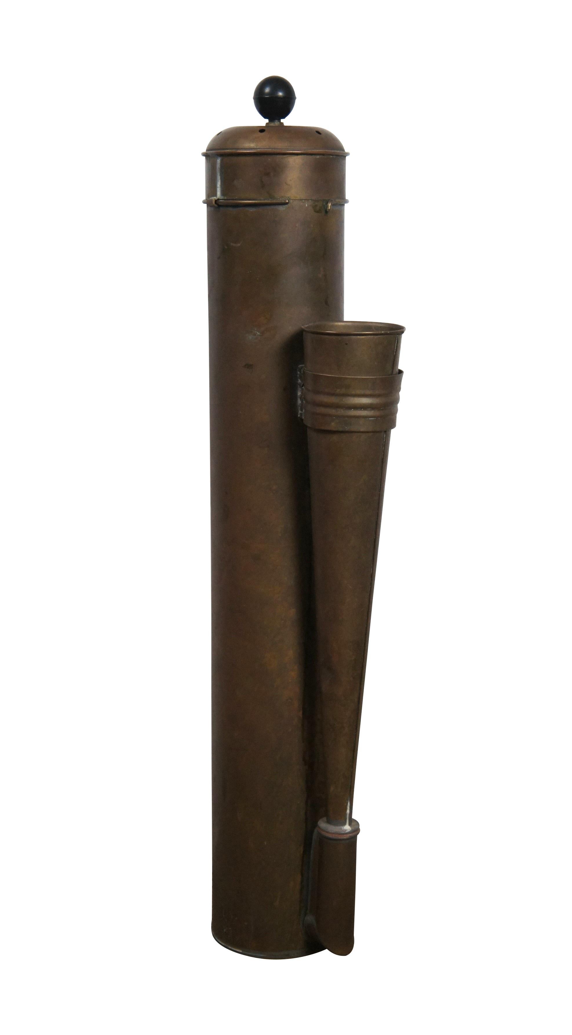 Late 19th - early 20th century brass plunger operated fog horn. Cylindrical body with horn attached to one side, pierced lid, and round, black finial on the plunger. Pair of brackets on the back for mounting in place.

Dimensions:
7.5