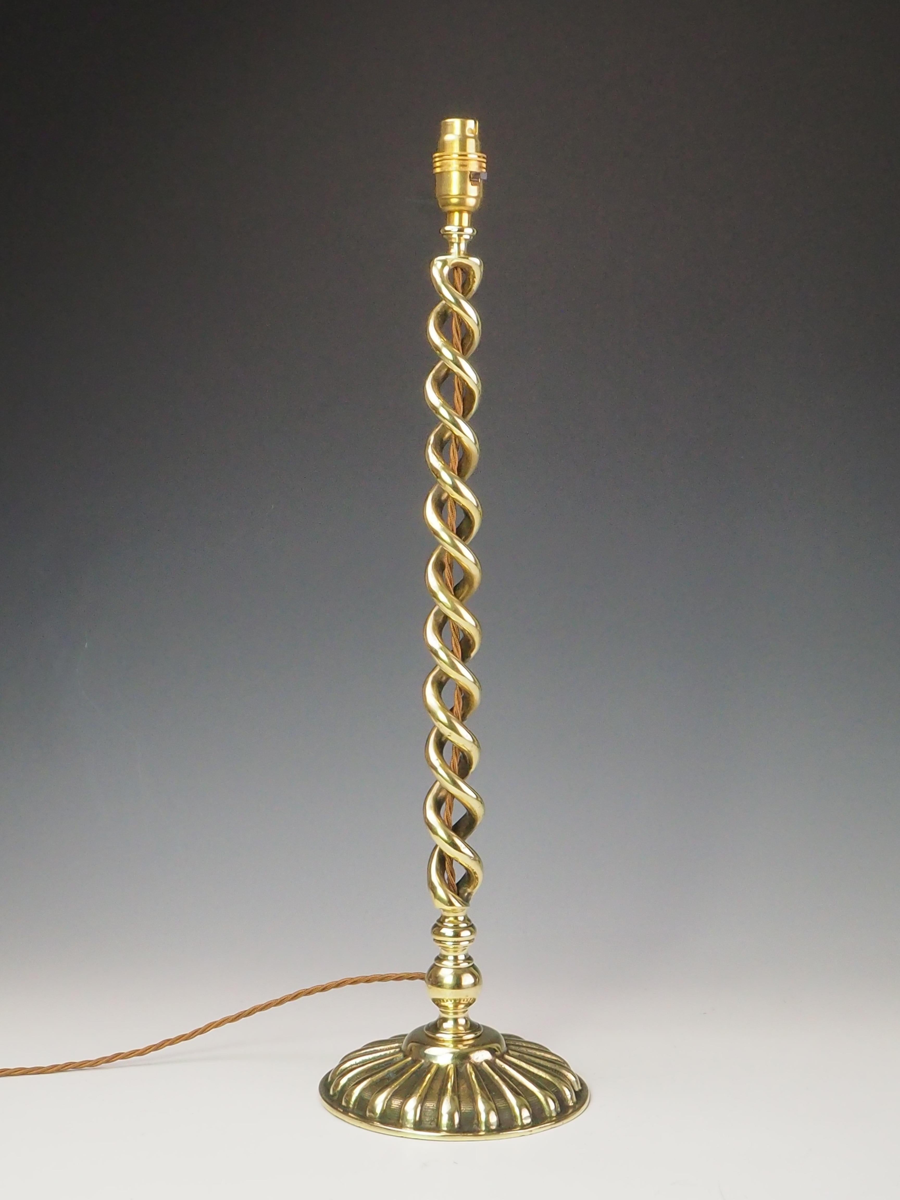 Antique Brass Open Twist Table Lamp

English 19th Century Antique Brass Open Twist Table Lamp. A captivating piece of Victorian craftsmanship. This lamp features a graceful open twist design, skillfully forged in gleaming brass, reflecting the era’s
