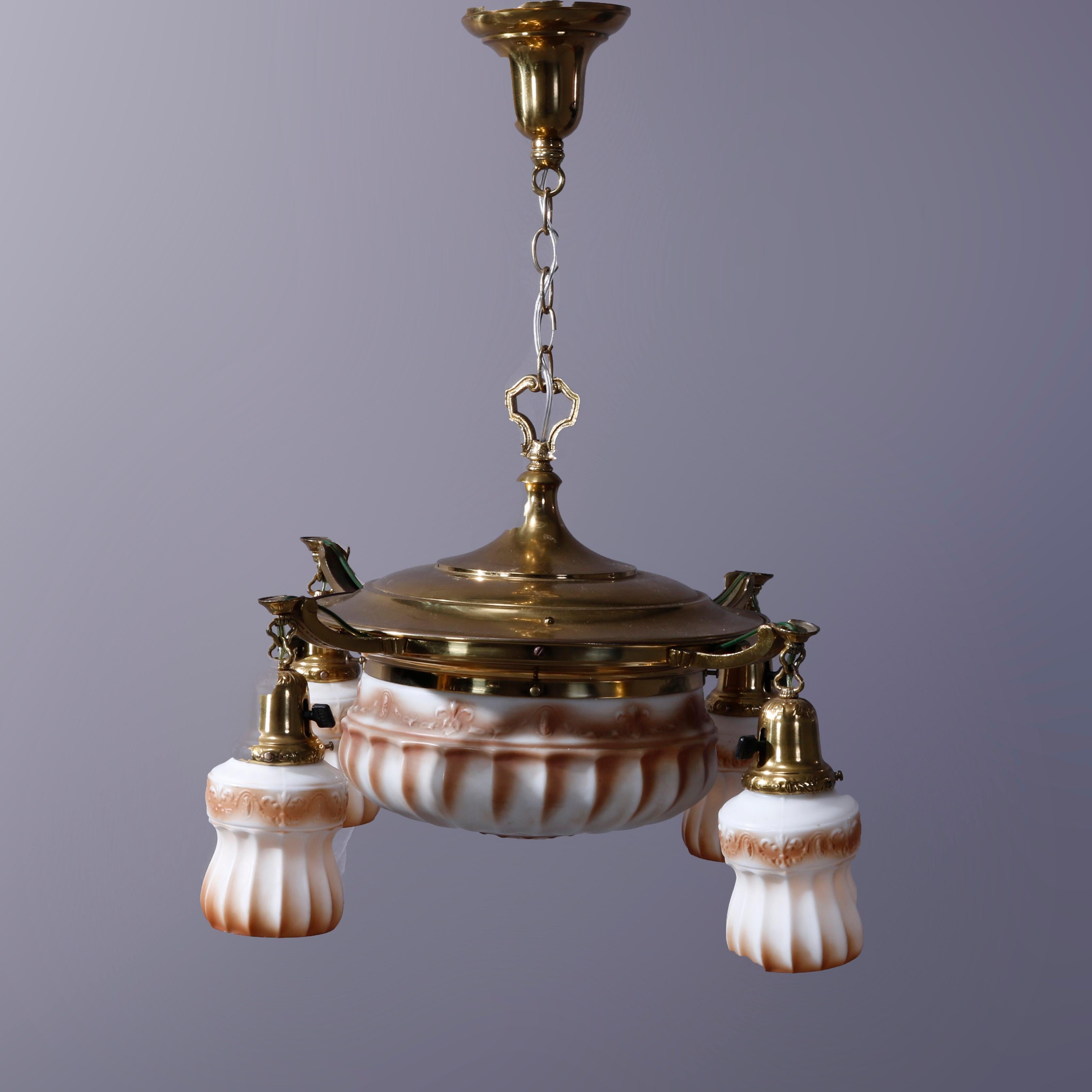 An antique Victorian ceiling fixture offers brass frame with central dome pan light and four drop-lights having glass shades, c1920

Measures - 33''h x 23''w x 23''d; 7'' chain.

Catalogue Note: Ask about DISCOUNTED DELIVERY RATES available to most
