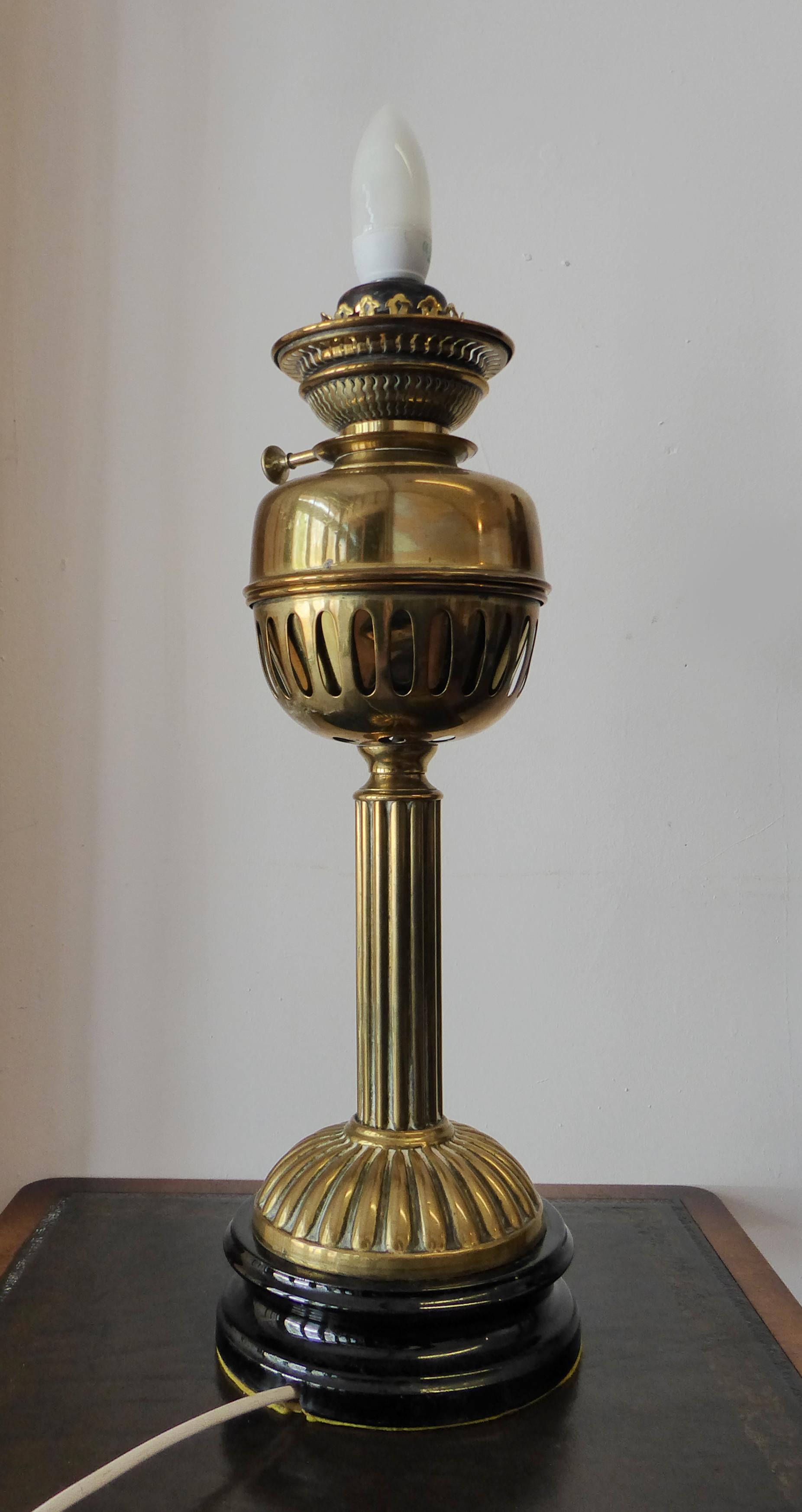 The brass column resting upon a circular brass base seated on a turned marble plinth. The original paraffin bowl and wick adjustment is all there, and if one wished to re-convert it back to the electricity this could be readily done.
with an