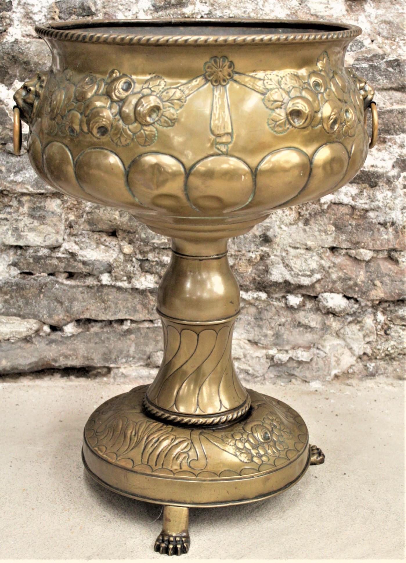 This antique planter is unsigned, so no specific maker could be determined, but it is presumed to have been made in the United States in circa 1890 in the period Victorian style. The planter is constructed of brass which has been heavily decorated