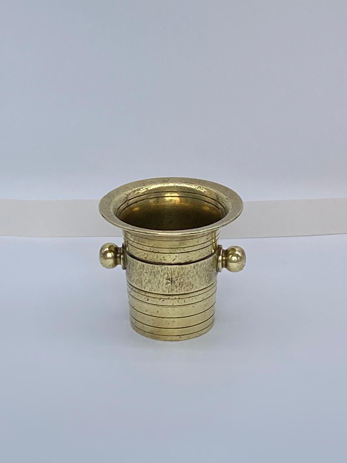 Antique Brass Pestle And Mortar, German, mid 19th Century. Both the pestle and mortar having reeded decoration, the mortar with rounded cast handles stands 11cm high. All original, good antique condition.