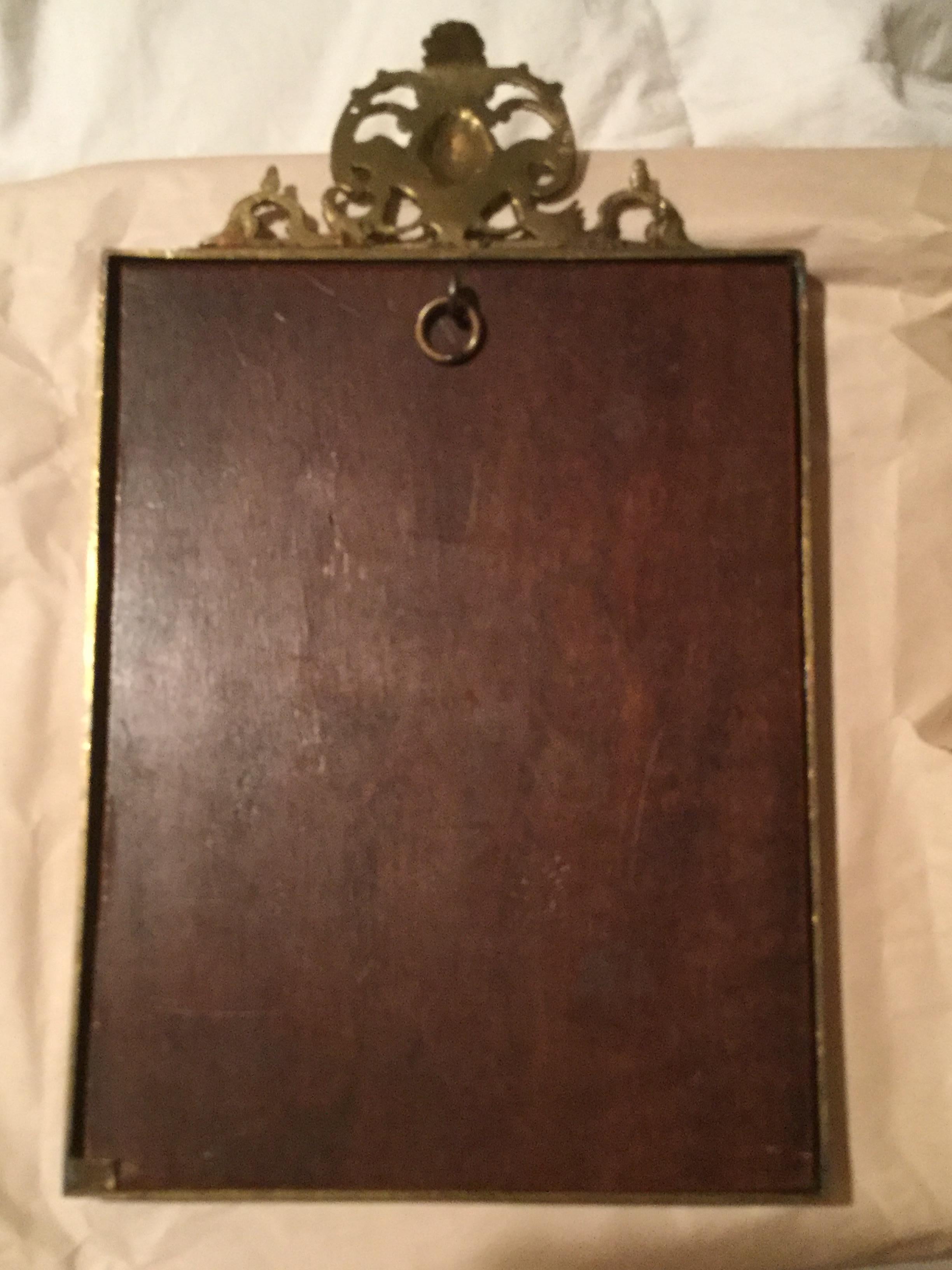 Heavy turn of the 20th century solid brass or bronze picture frame with very intricate detailing. Back appears to be mahogany.
Some of the clips are off on the back and there is a ring on the back for wall hanging.
Measures: Inside picture area