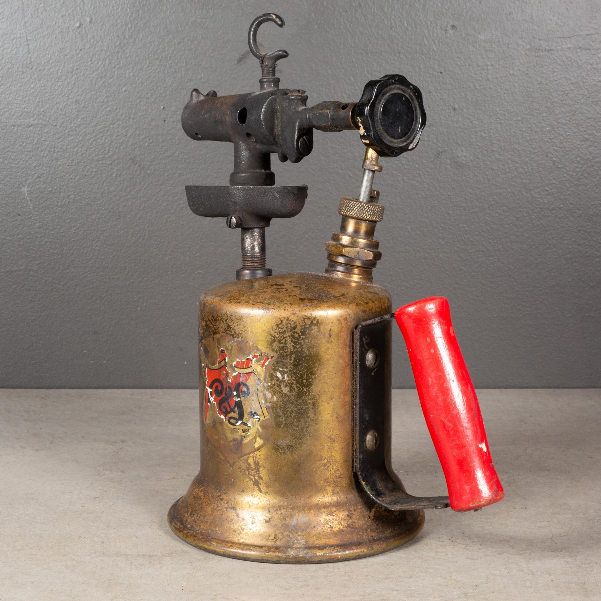 ABOUT

An antique 20th century plumber's blowtorch with solid brass canister, red wooden handle and Bakelite knob. 

Shown with life size hand model for scale. 

    CREATOR Clayton & Lambert. 
    DATE OF MANUFACTURE c.1920.
    MATERIALS AND