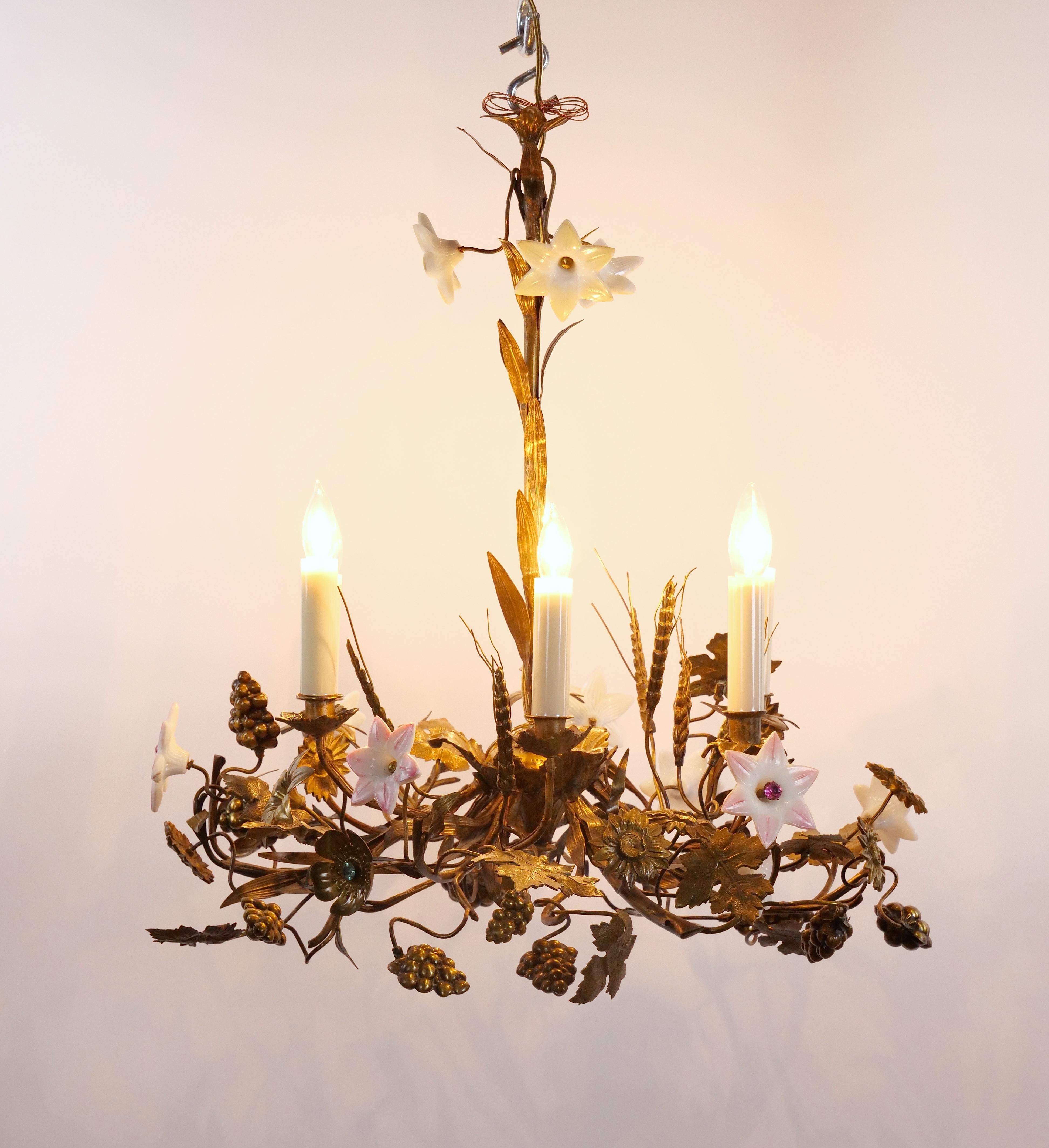 Extraordinary and exceptionally rare antique chandelier, meticulously handcrafted from brass and various metals. This masterpiece showcases exquisite clusters of grapes, intricately detailed grapevine leaves, and an assortment of meticulously