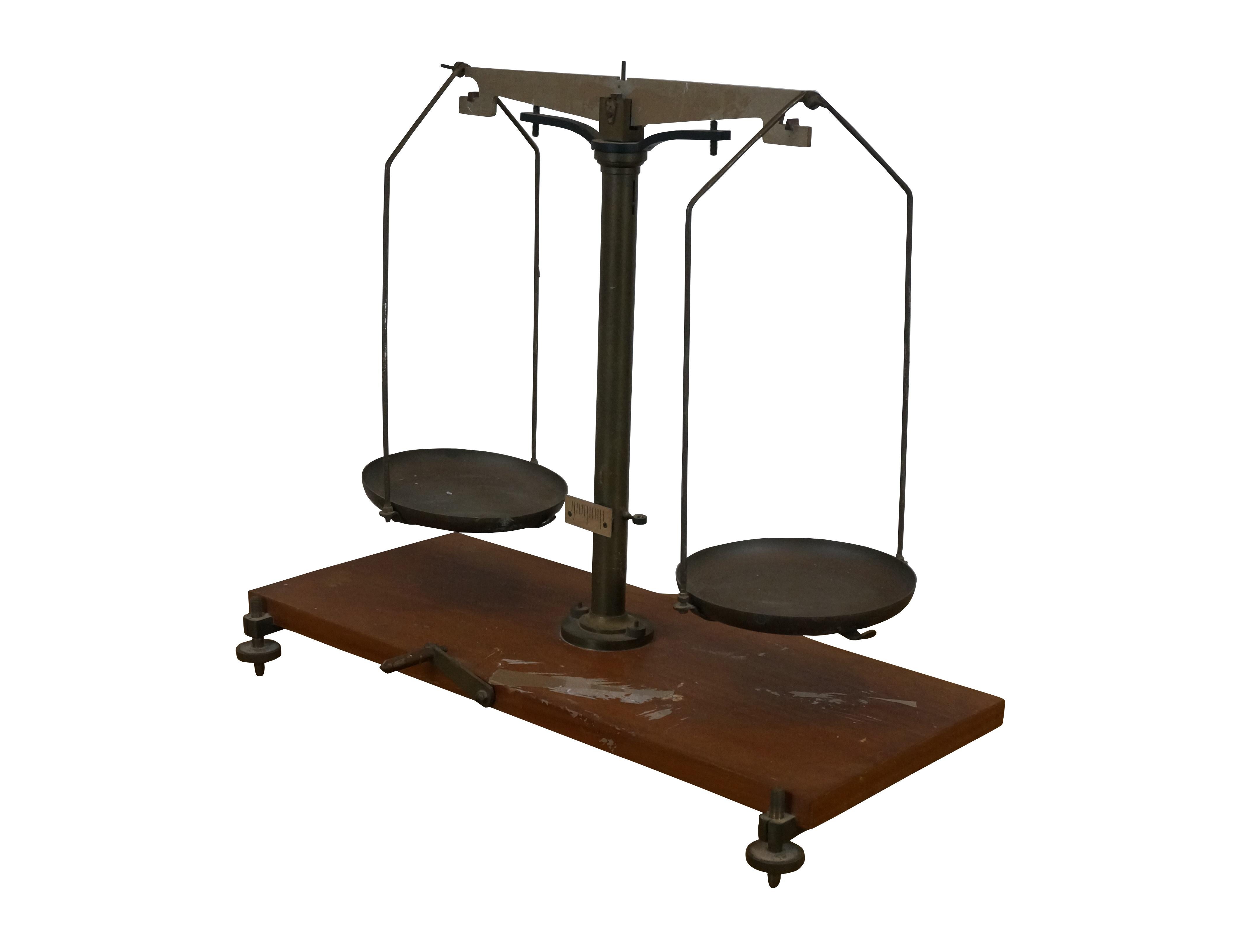 Antique set of scales featuring a rectangular wood base, brass hardware and pans.

Dimensions:
18.75