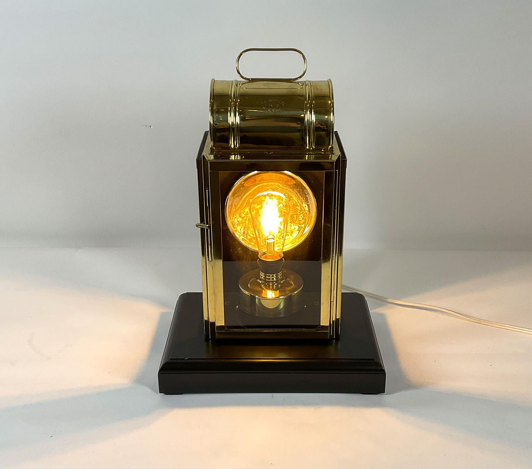 Yacht cabin lantern with impressed maker’s name of the Porter Company, New York. Mounted to a wood base. This has been meticulously polished and lacquered to a high level. Original reflector in case. The burner tank has been fitted with an electric
