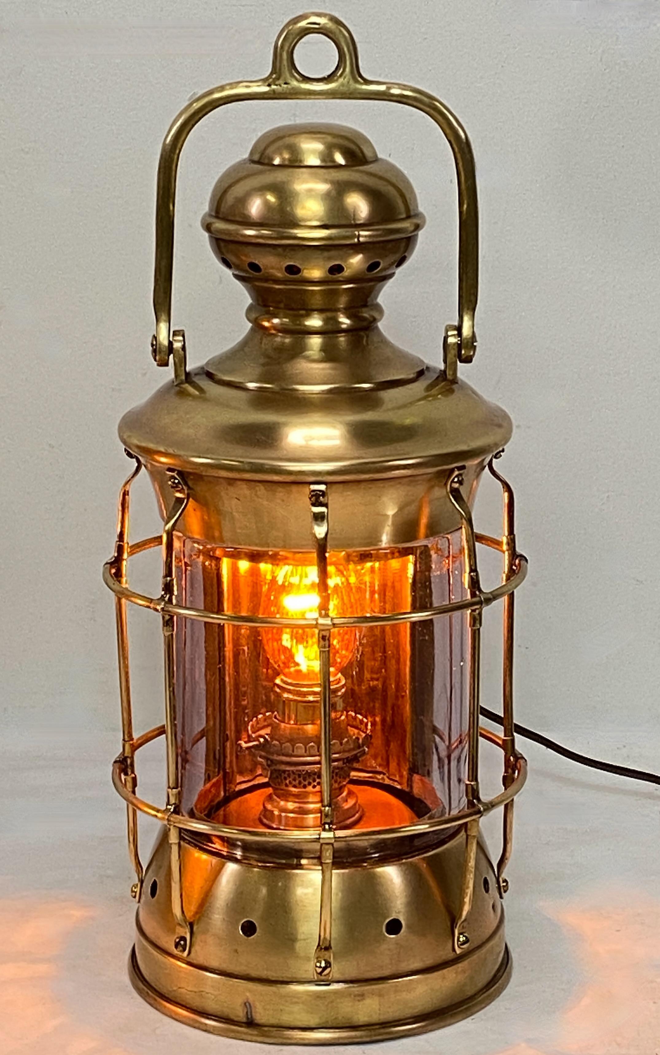 Antique brass and glass nautical lantern. Has original oil font, recently re-wired as a lamp.
Original makers plaque on back.
In excellent condition.