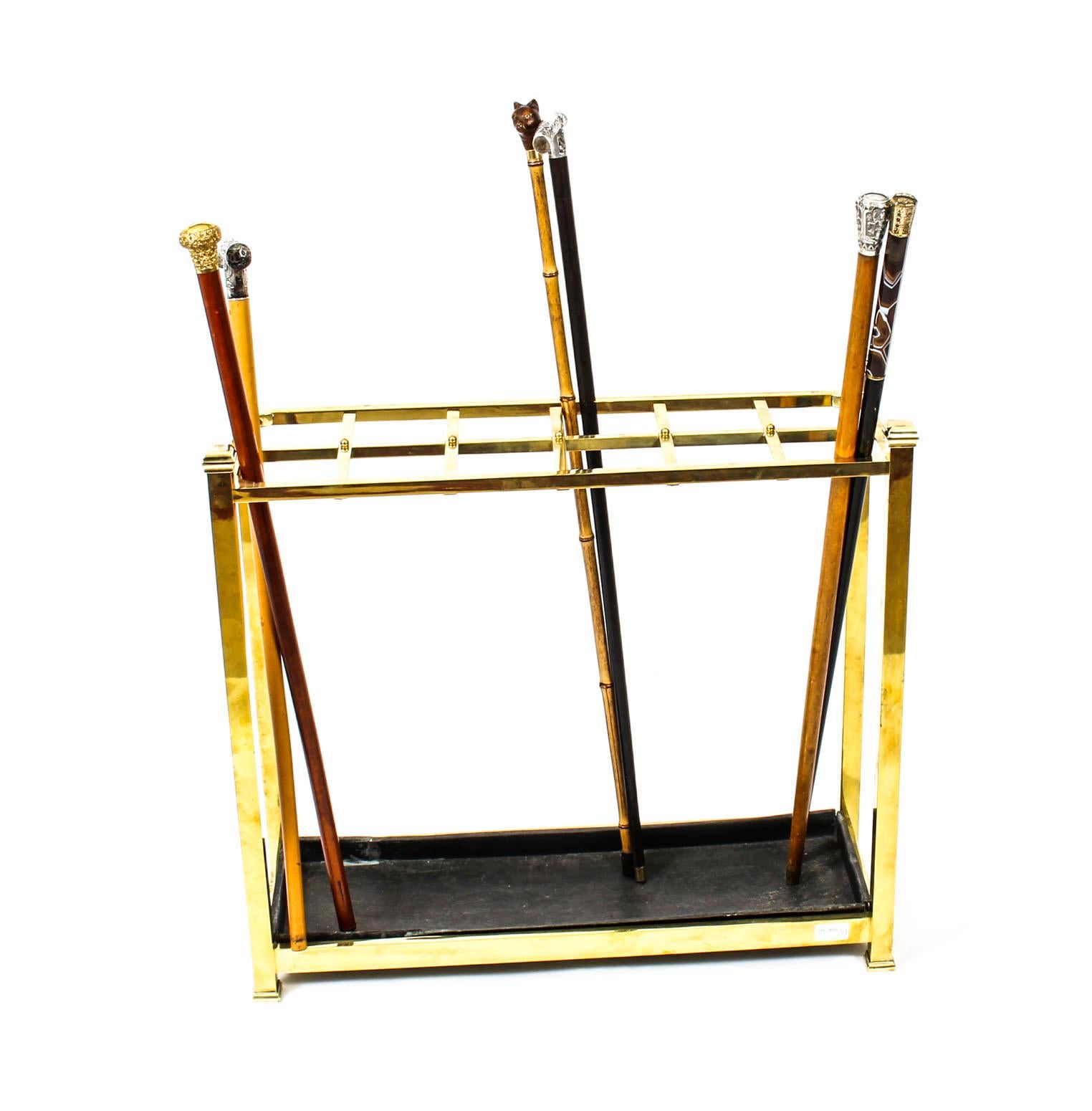 This is a very elegant brass umbrella and walking stick stand, dating from the late 19th century. 

This stunning stand is of rectangular shape with four stylish square corner finials and twelve divisions to display your walking sticks neatly.
