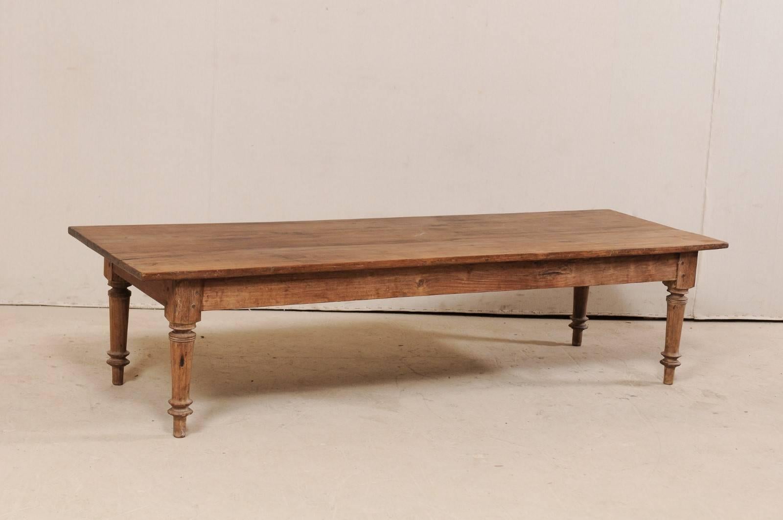 A Brazilian wooden bench (or table) from the early 20th century. This antique bench from Brazil, approximately 6.25 feet in length, has been constructed of a tropical hardwood and features a long, rectangular-shaped top, plain skirt, and supported