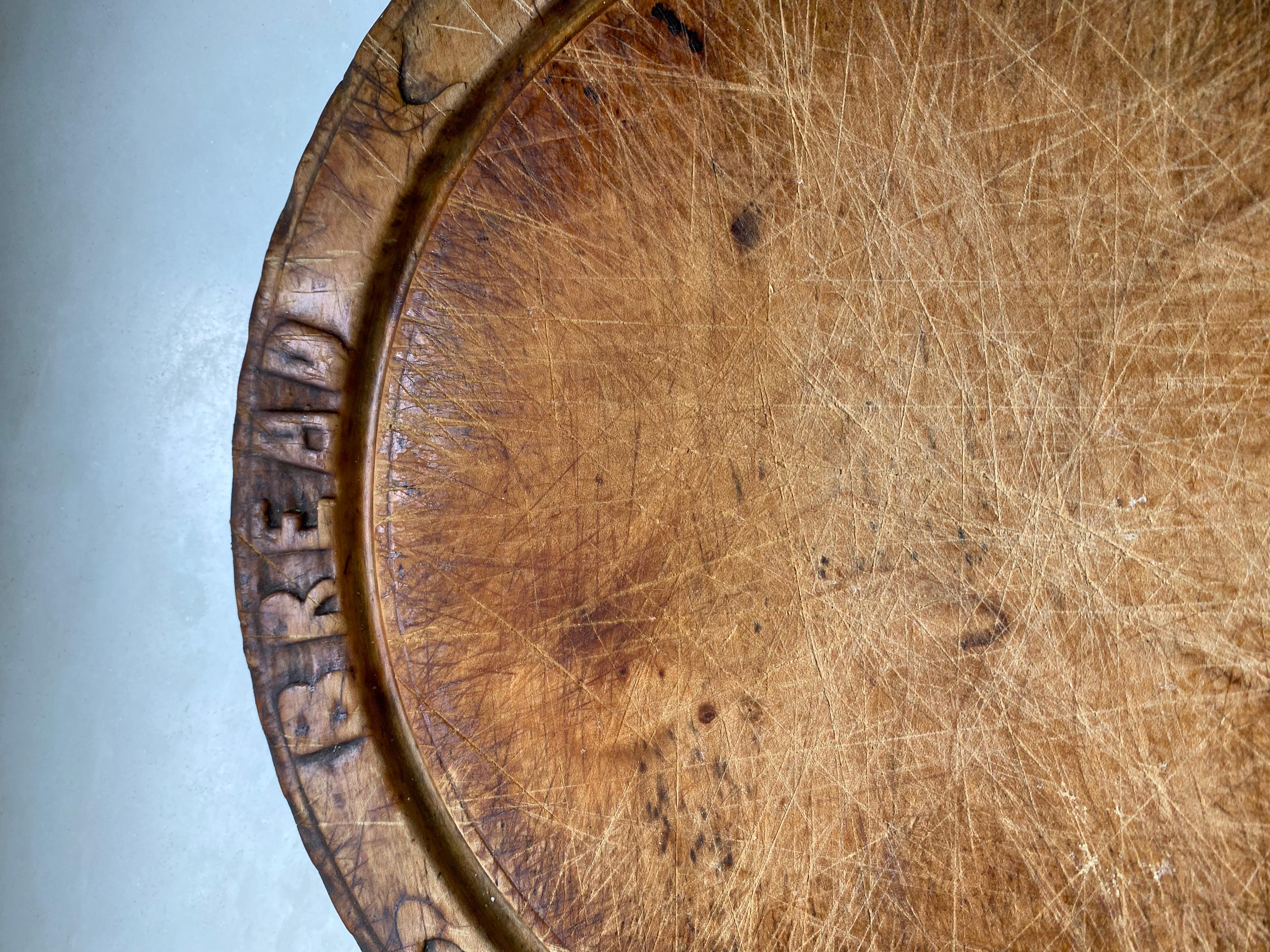 Once standard item found in an English country home, these antique Victorian hand carved breadboard have become a rarity. This particular one has a warm timeless rich aged patina. The bread board is hand carved with 