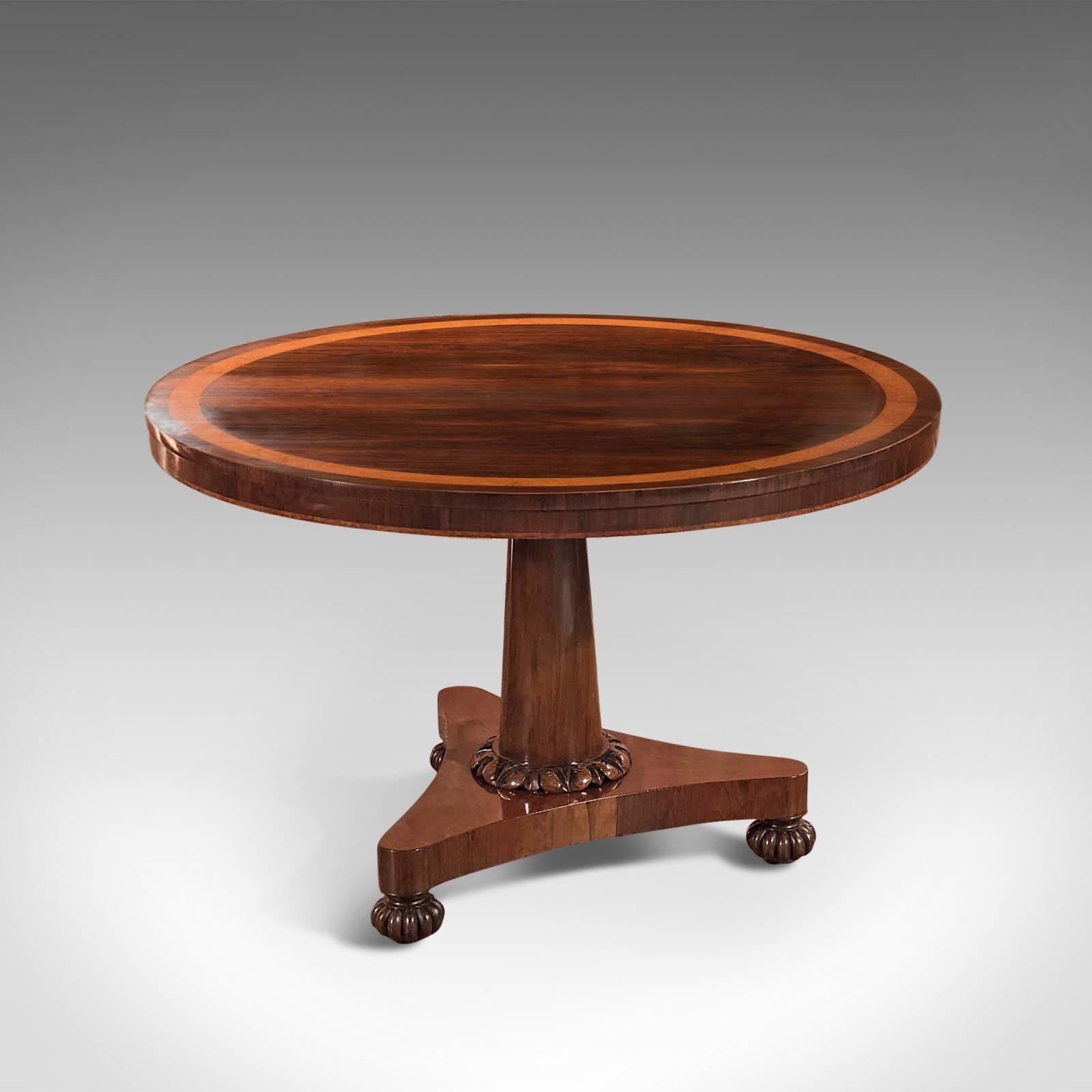 This is an antique, William IV rosewood, tilt-top breakfast table dating to circa 1830.

Heralding from the late Regency period, this superior table modestly displays the excesses of top quality timber through a highly polished