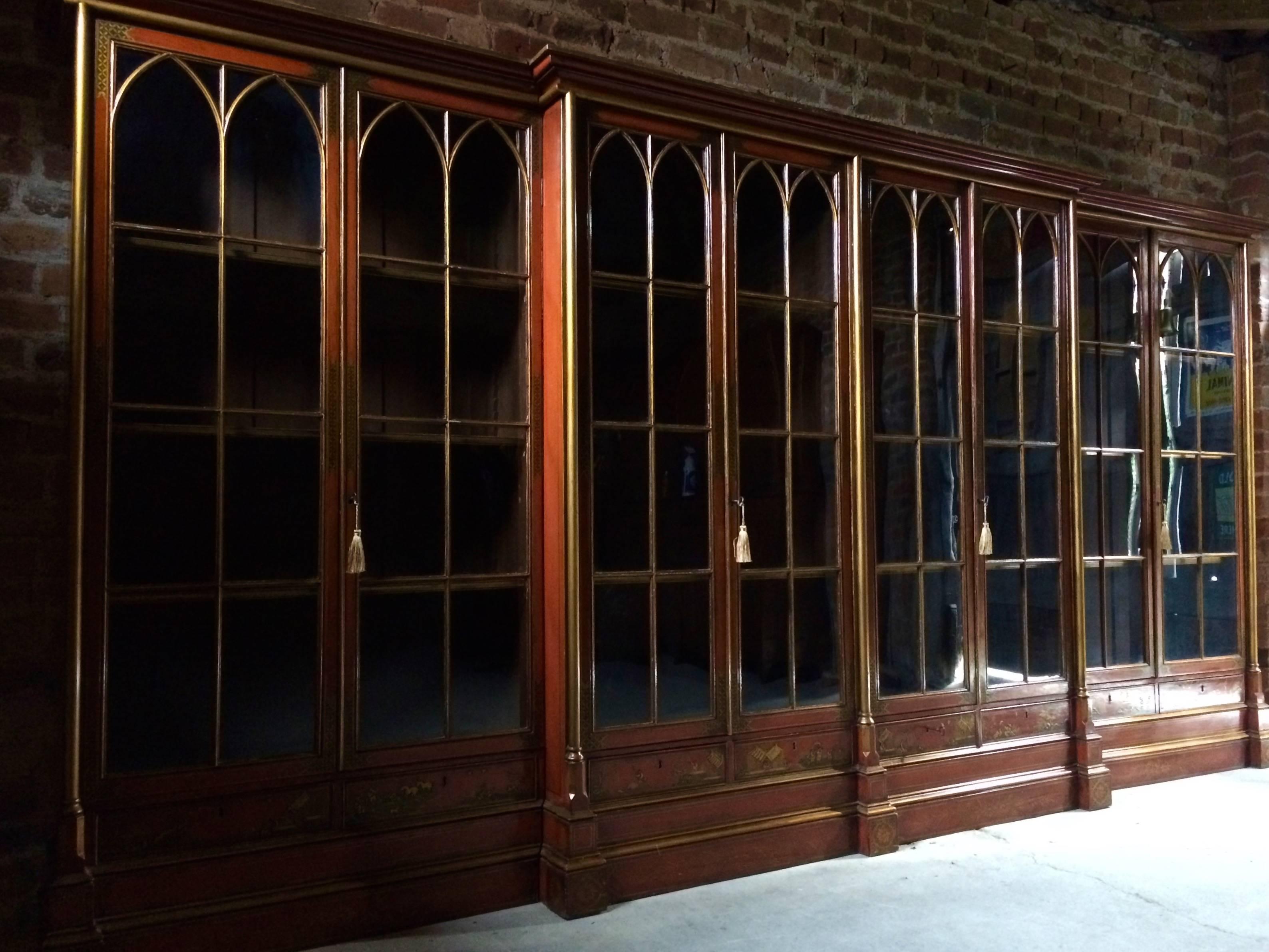 Magnificent large and imposing George III Japanned breakfront library bookcase dating to circa 1820, the six glazed doors with Moorish style astragal glazed arches above eight small drawers below each with individual scenes of villages, rivers and