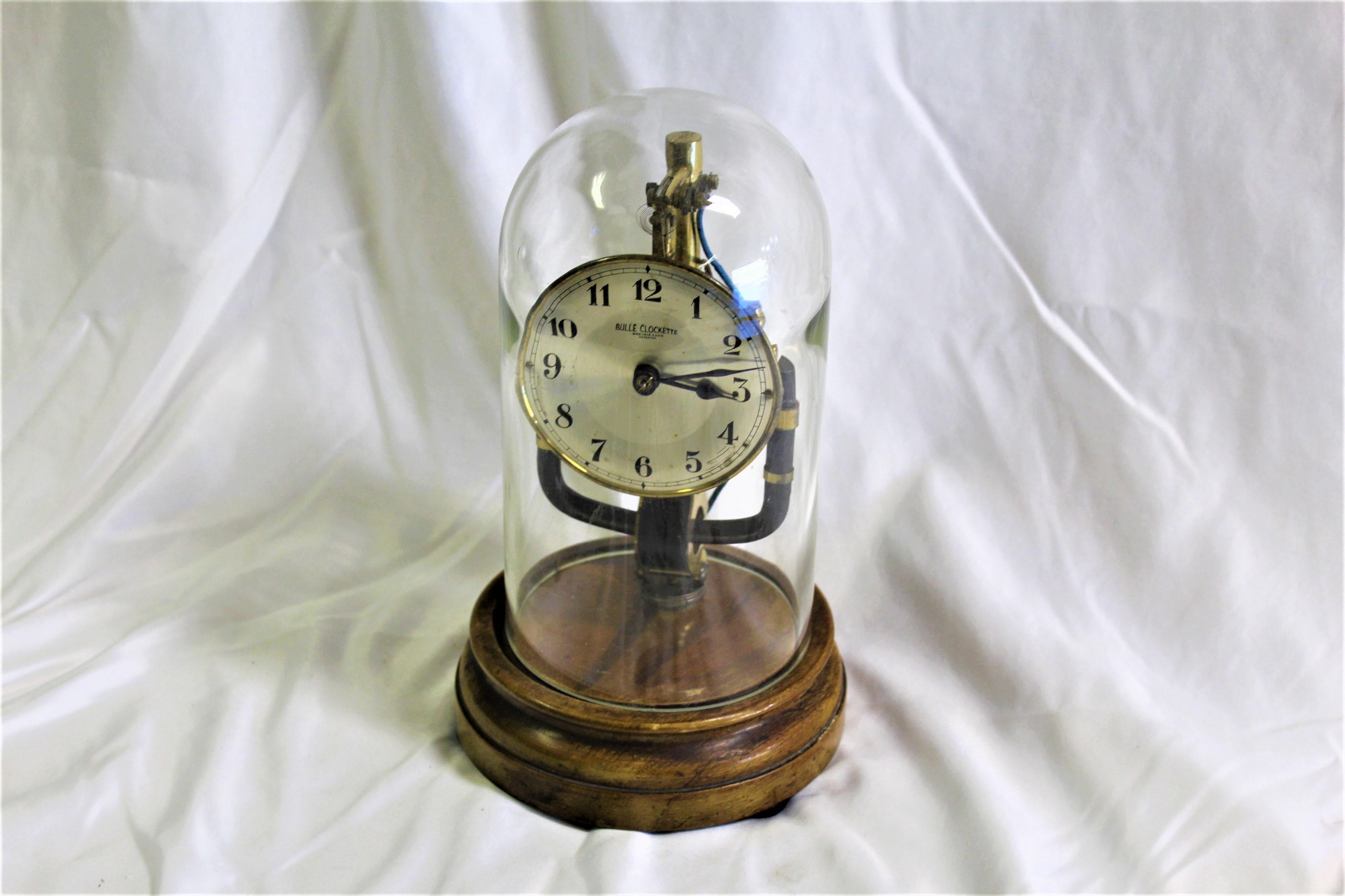 This is a small Clockett Clock made by Bulle. Picked it up in London long ago. Battery Magnetic clock kept under glass dome. The glass dome maybe a replacement. They never last long. Requires special packing and shipping. Can quote at time of sale.