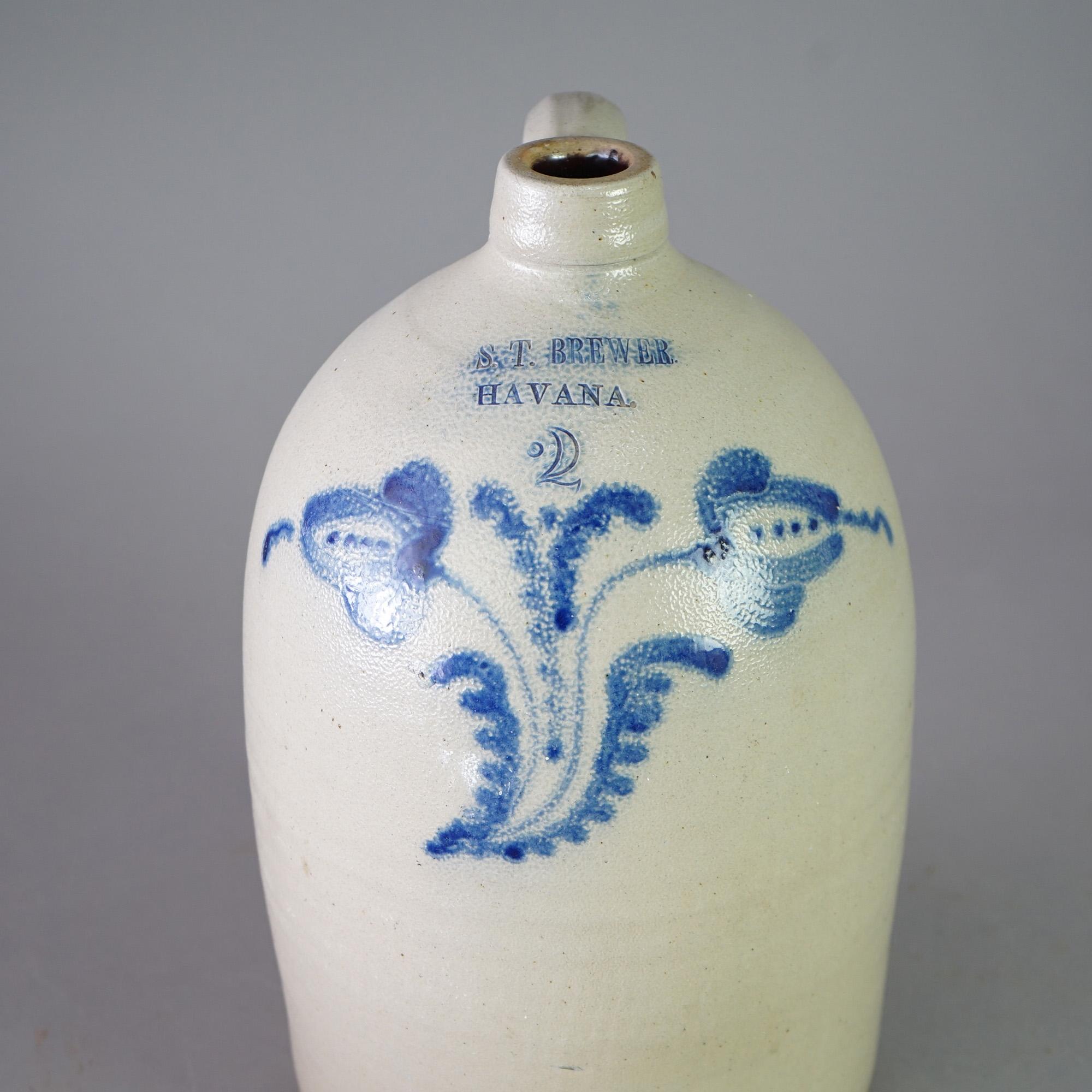 An antique Brewer salt glazed stoneware jug offers blue decorated floral design and maker stamp as photographed, c1880

Measures- 14''H x 8.5''W x 8.5''D