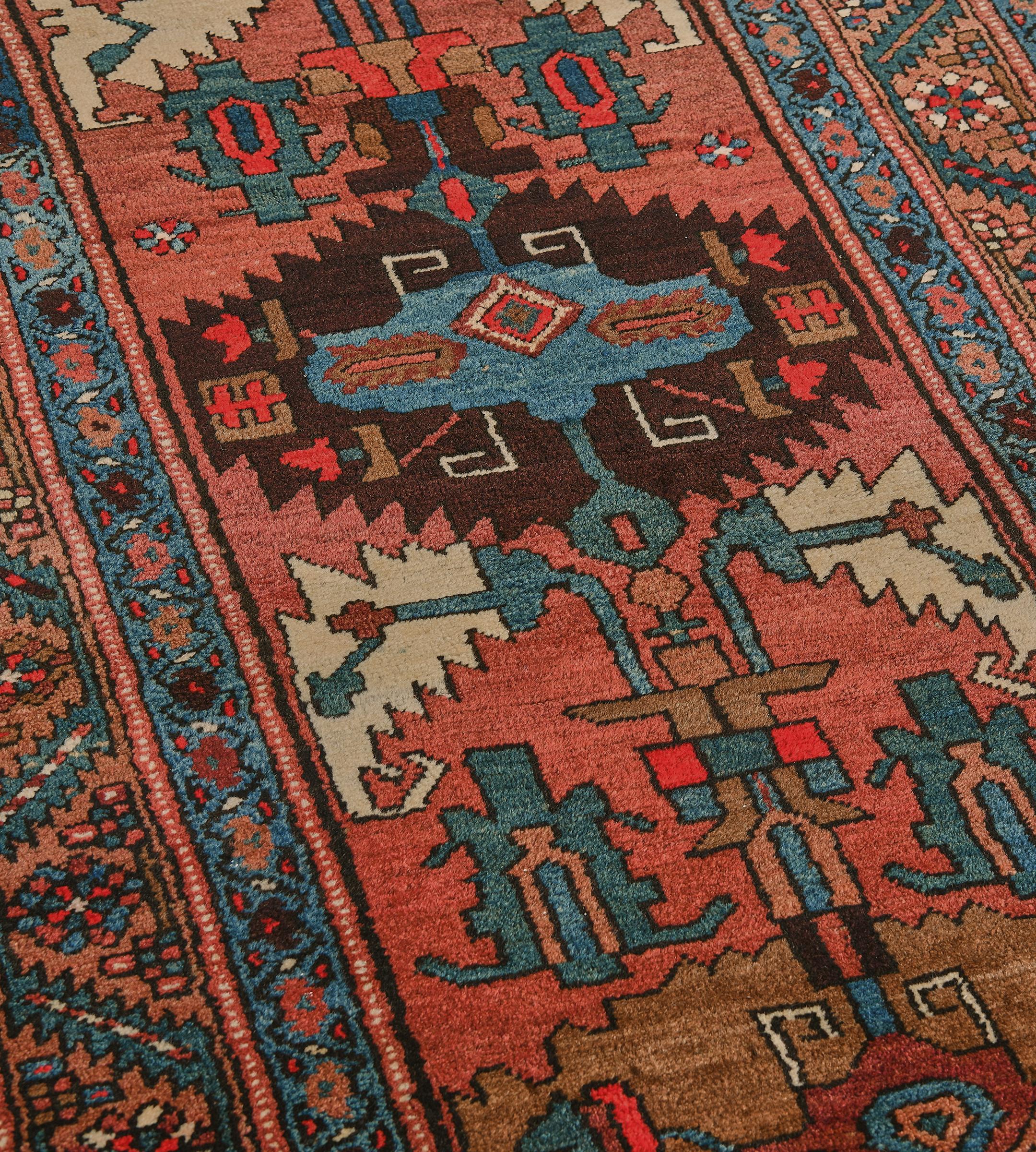 This antique Serab runner is a brick-red field with a column of six polychrome lozenges of sea-green, buff-brown, chocolate-brown and light terracotta-pink each lozenge containing a central hooked lozenge and stylized floral motifs, linked by ivory