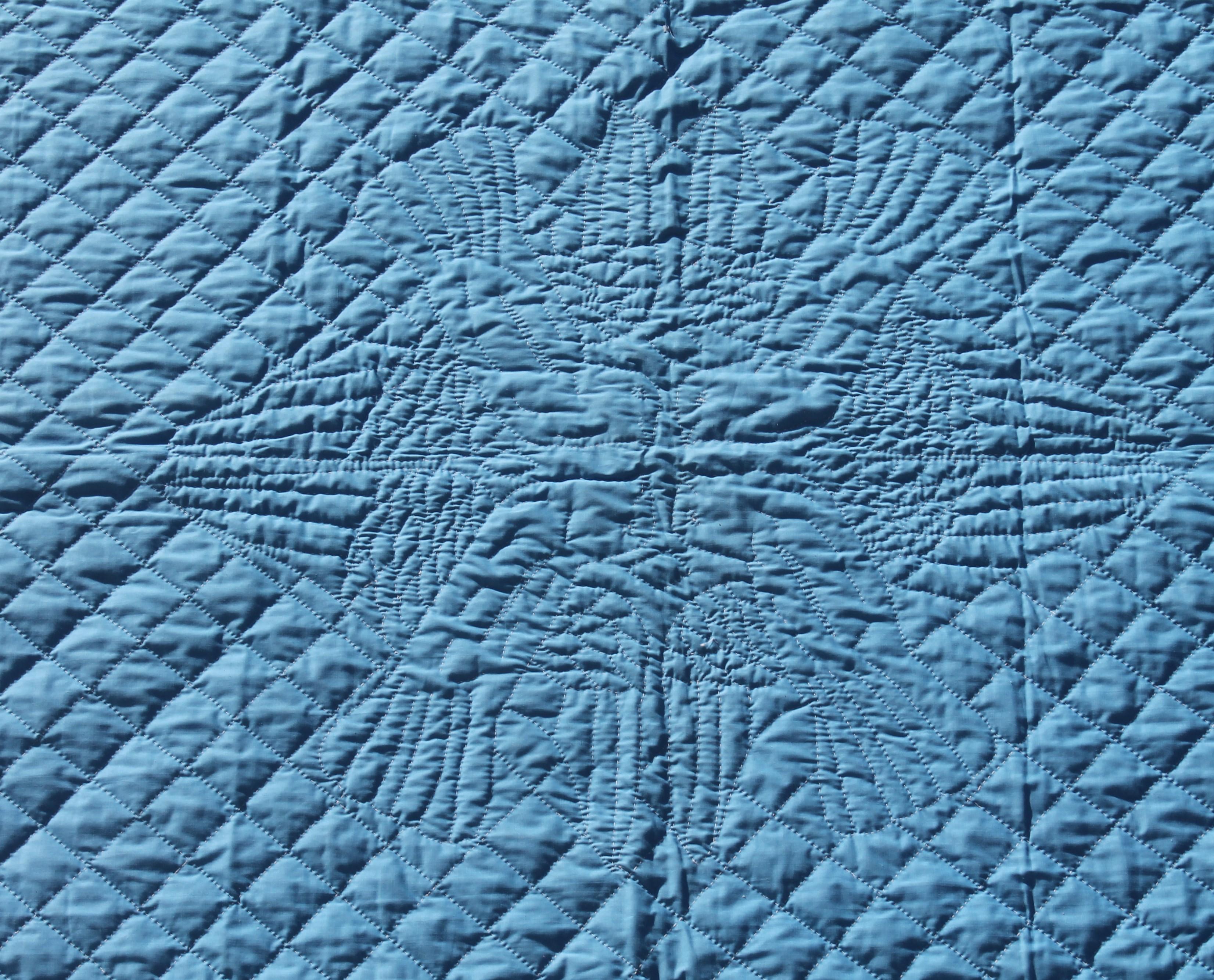 This finely quilted bridal quilt is reversible and was made in Lancaster County Pennsylvania. It is blue on one side and white on the other side. Heavy beautiful feather quilting. Would make a Fantastic wedding gift Take notice of the four doves in