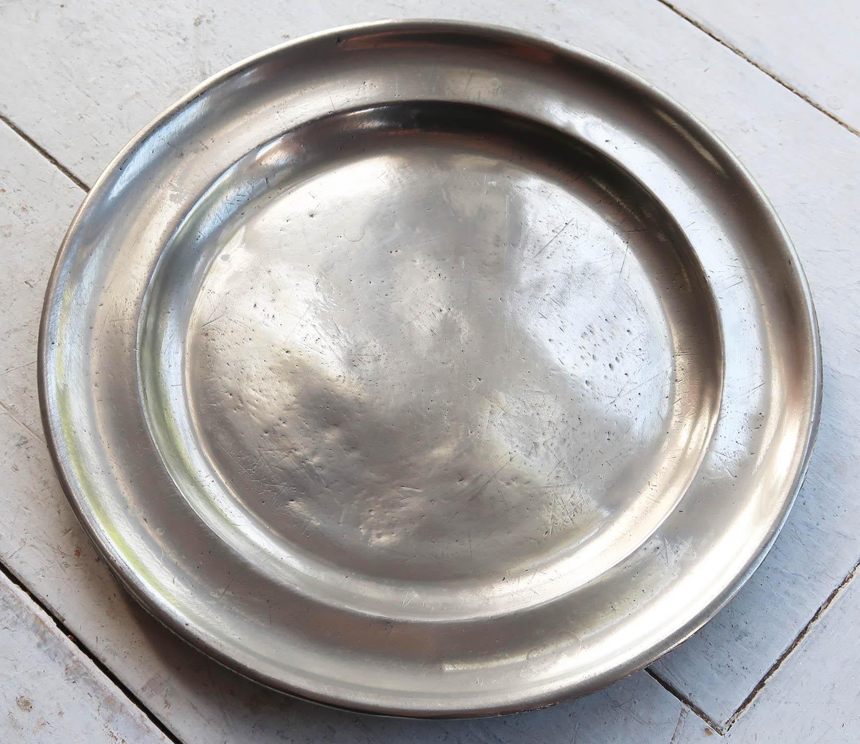 Lovely highly polished pewter plate.

Evidence of a rubbed touchmark on the underside. Shown in the last image.

The pewter has been polished to its original shine to imitate polished silver. It was known as the Poor Man's Silver.

The great thing