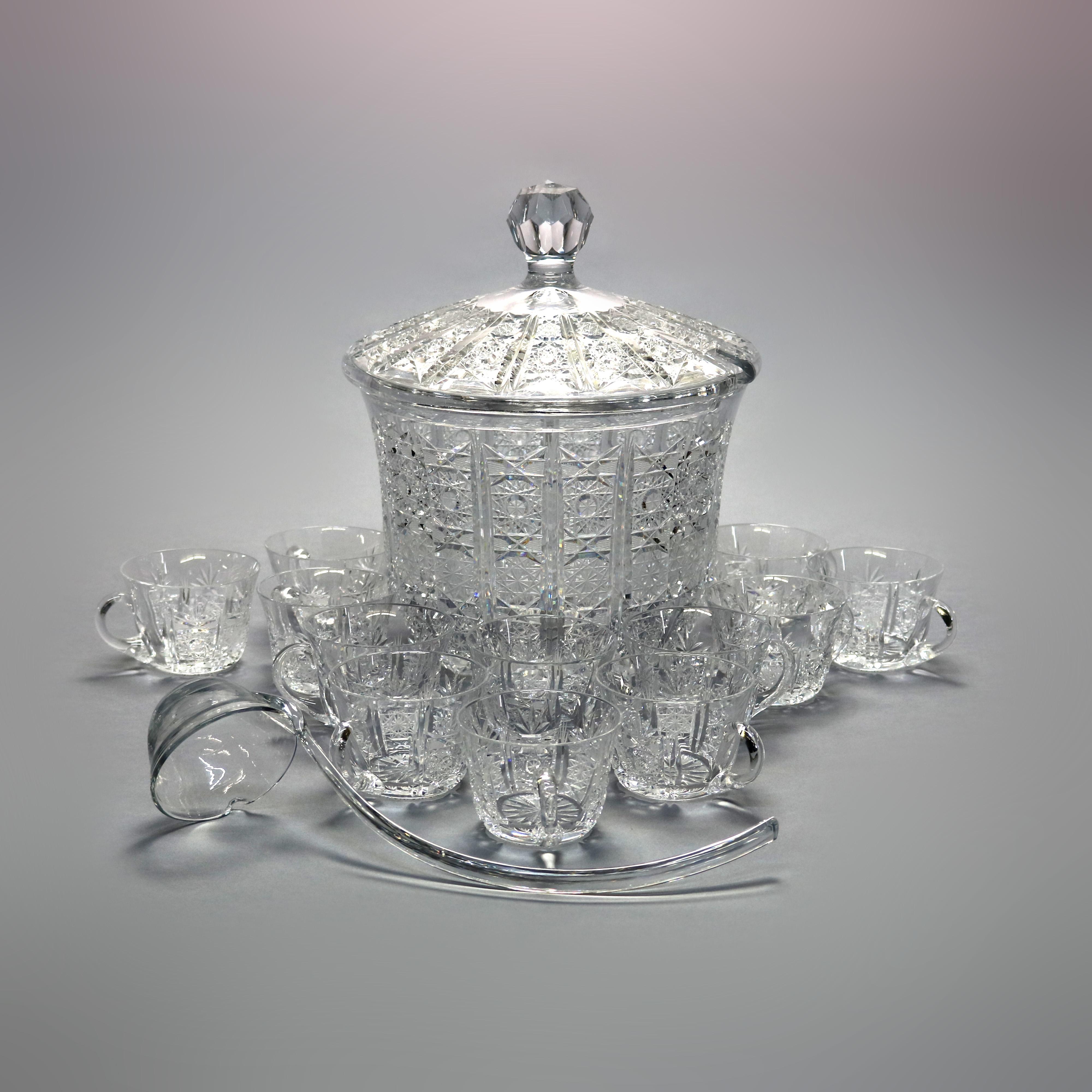An antique punch bowl set by Waterford of Ireland offers covered cut crystal lidded punch bowl with twelve handled cups and ladle, signed Waterford, c1930 

Measures: Ladle 13.5