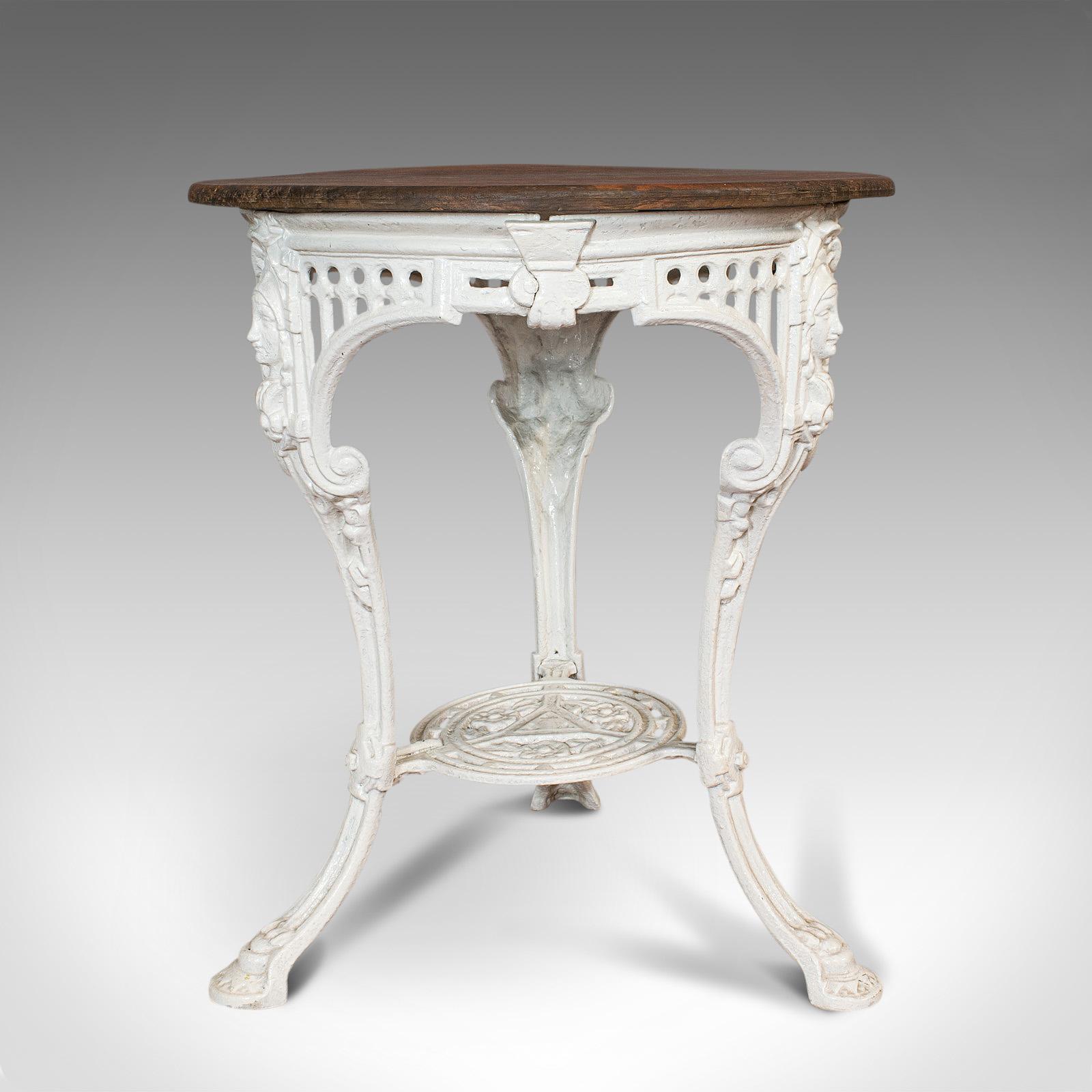 This is an antique Britannia table. An English, cast iron and cedar traditional garden table, dating to the late Victorian period, circa 1900.

Appealing example of a classic table
Displays a desirable aged patina
Cast iron frame in good order
